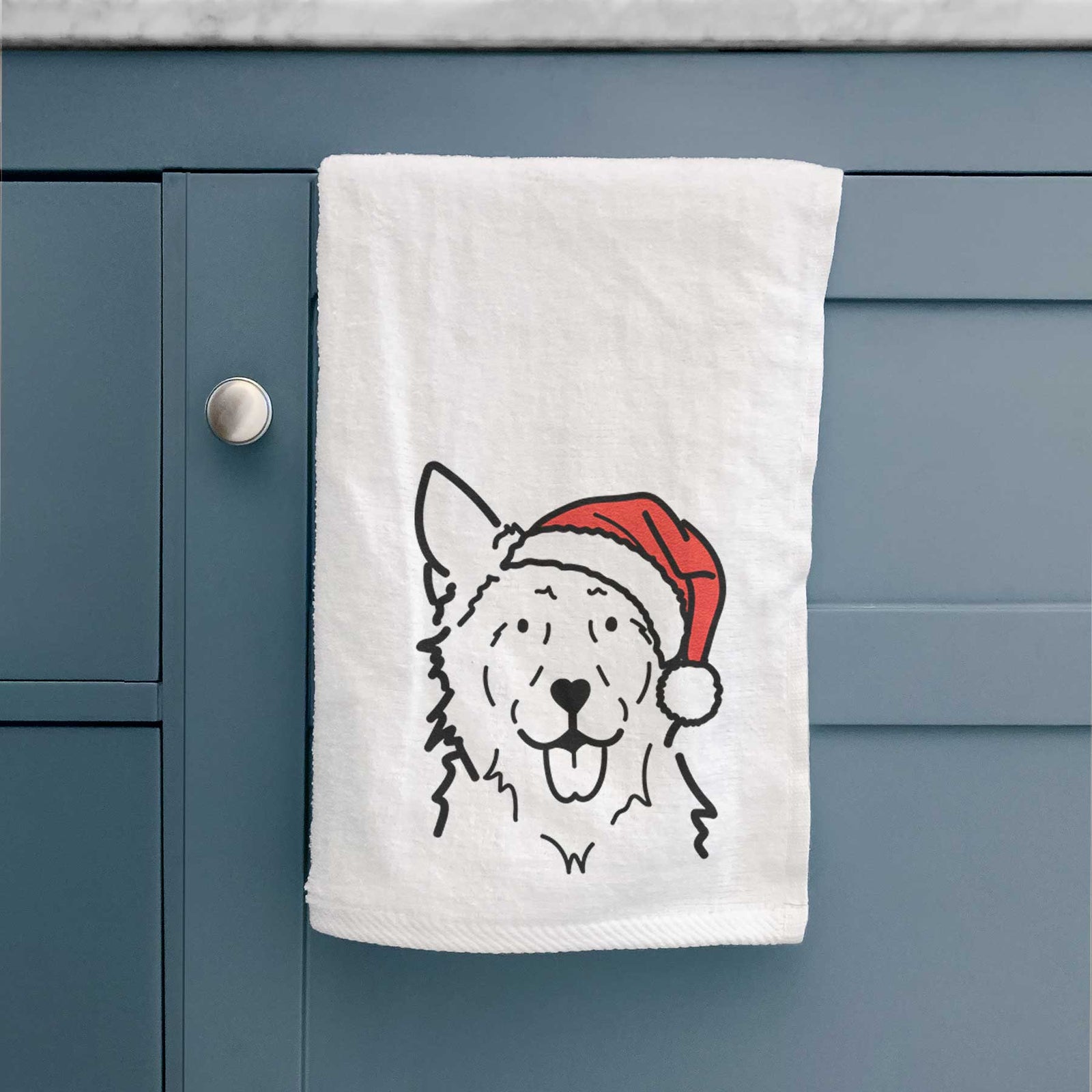 Minimalist line drawing of Jack the Mudi wearing a Santa hat on a decorative hand towel
