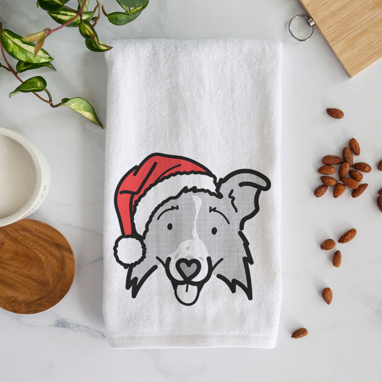 Minimalist line drawing of Jam the Border Collie 2.0 wearing a Santa hat on a decorative hand towel