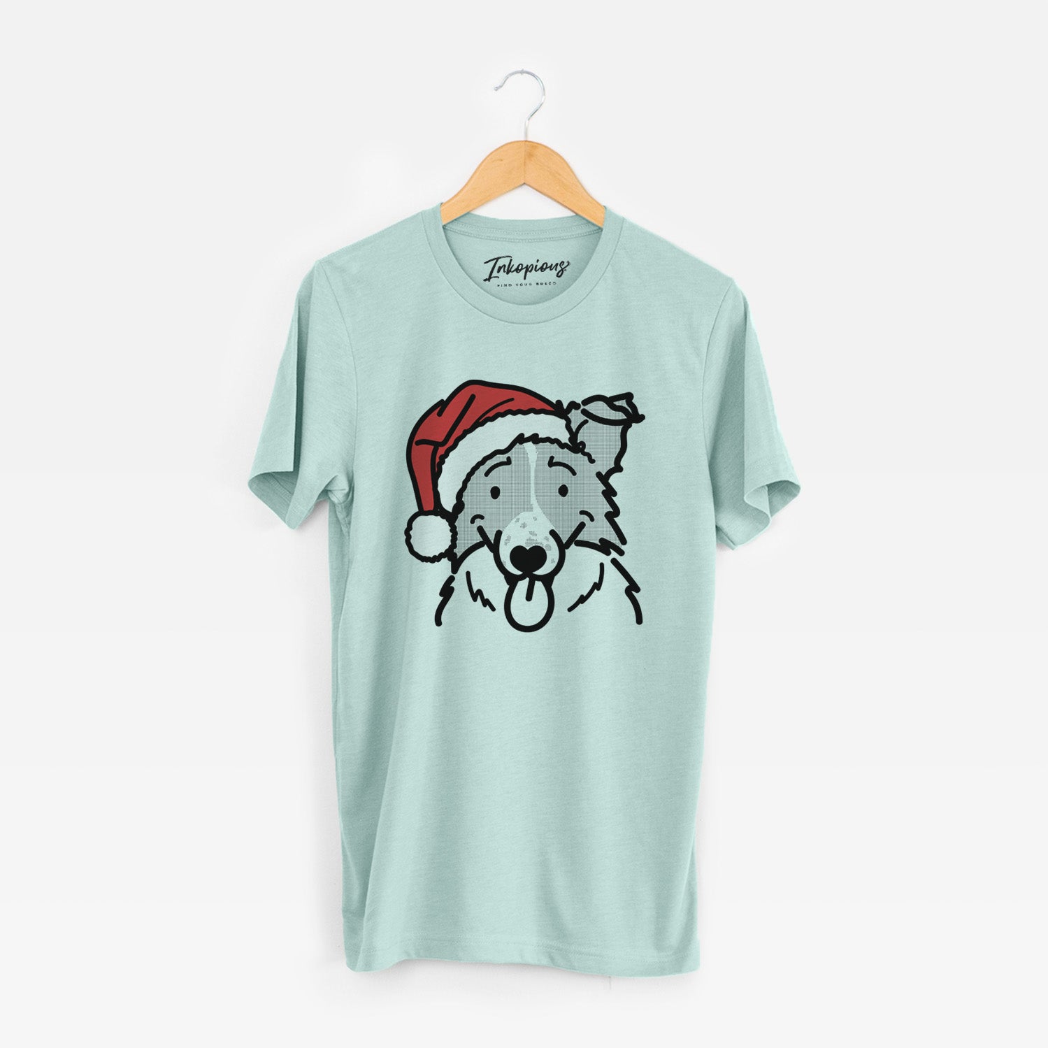 Minimalist line drawing of Jam the Border Collie wearing a Santa hat on a Heather Sage Unisex crewneck