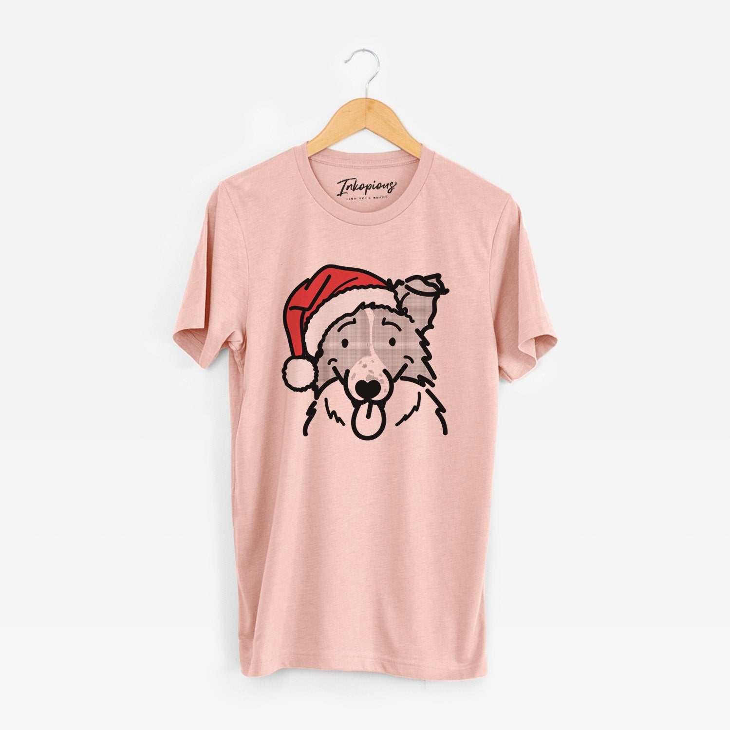 Minimalist line drawing of Jam the Border Collie wearing a Santa hat on a Peach Unisex crewneck