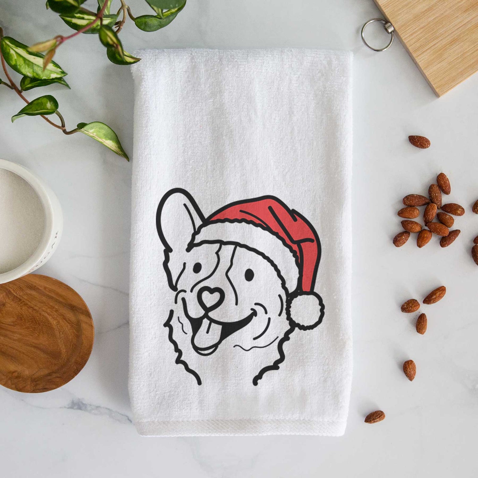 Minimalist line drawing of Lily the Corgi wearing a Santa hat on a decorative hand towel