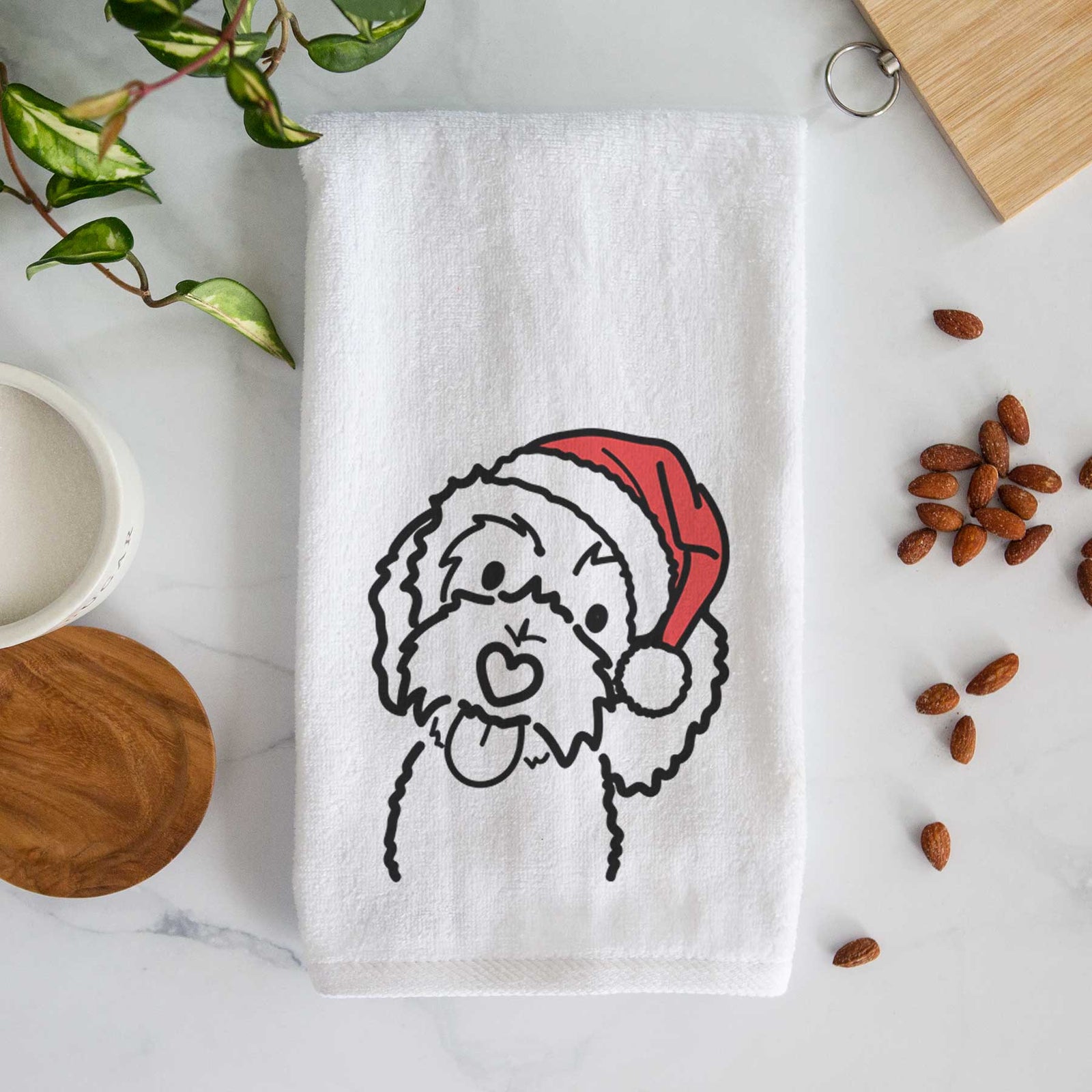 Minimalist line drawing of Mabel the Bernedoodle wearing a Santa hat on a decorative hand towel