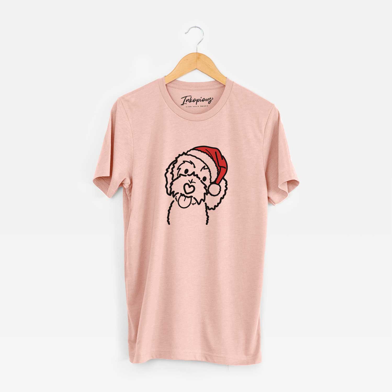 Minimalist line drawing of Mabel the Bernedoodle wearing a Santa hat on a Peach Unisex crewneck