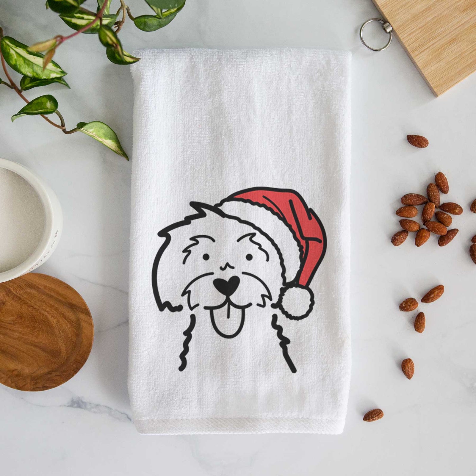 Minimalist line drawing of a Maltese wearing a Santa hat on a decorative hand towel