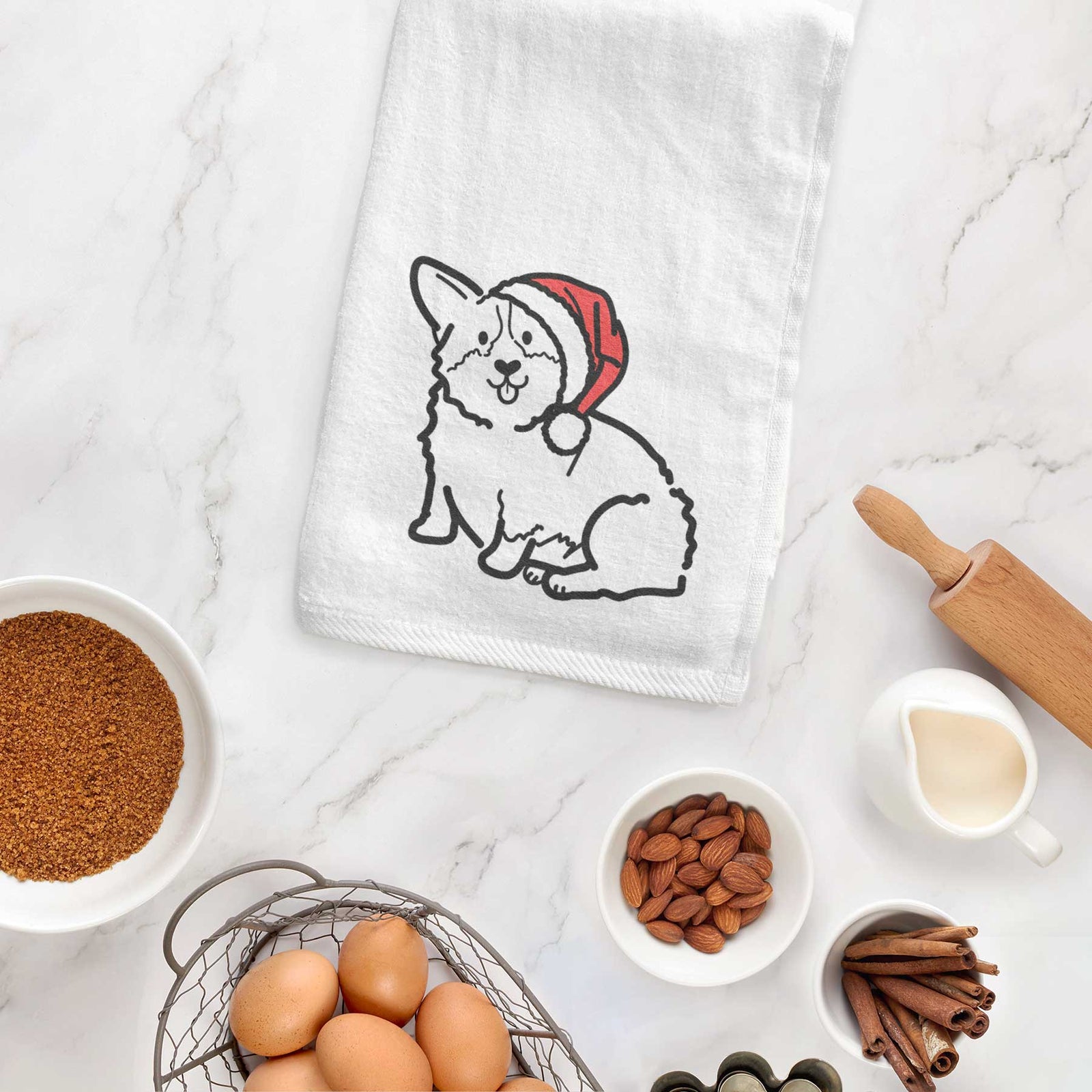 Minimalist line drawing of Millie the Pembroke Welsh Corgi wearing a Santa hat on a decorative hand towel