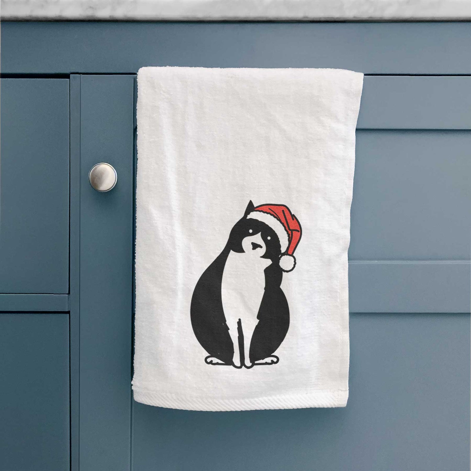 Minimalist line drawing of Oliver the Tuxedo Cat wearing a Santa hat on a decorative hand towel