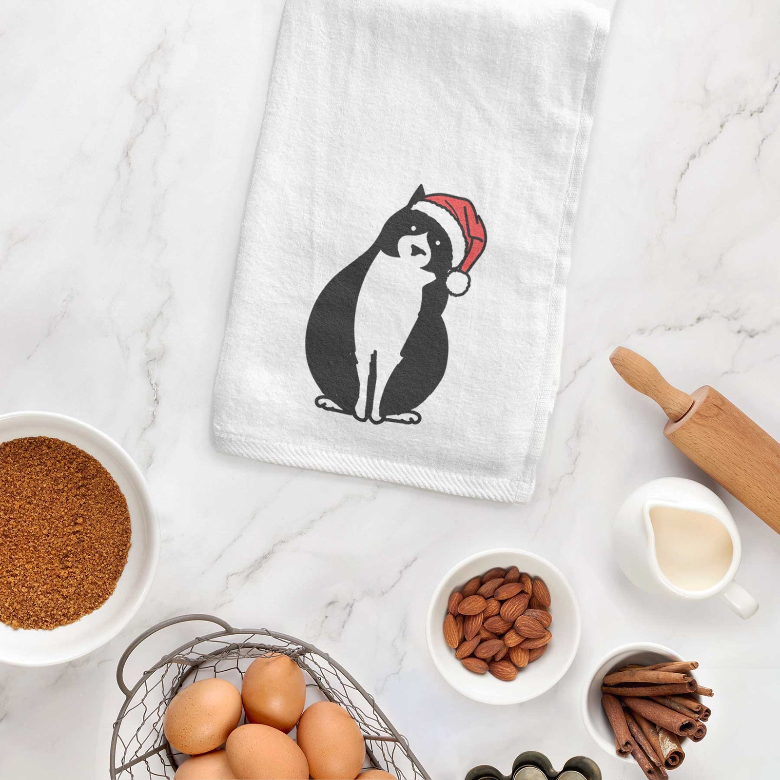 Minimalist line drawing of Oliver the Tuxedo Cat wearing a Santa hat on a decorative hand towel