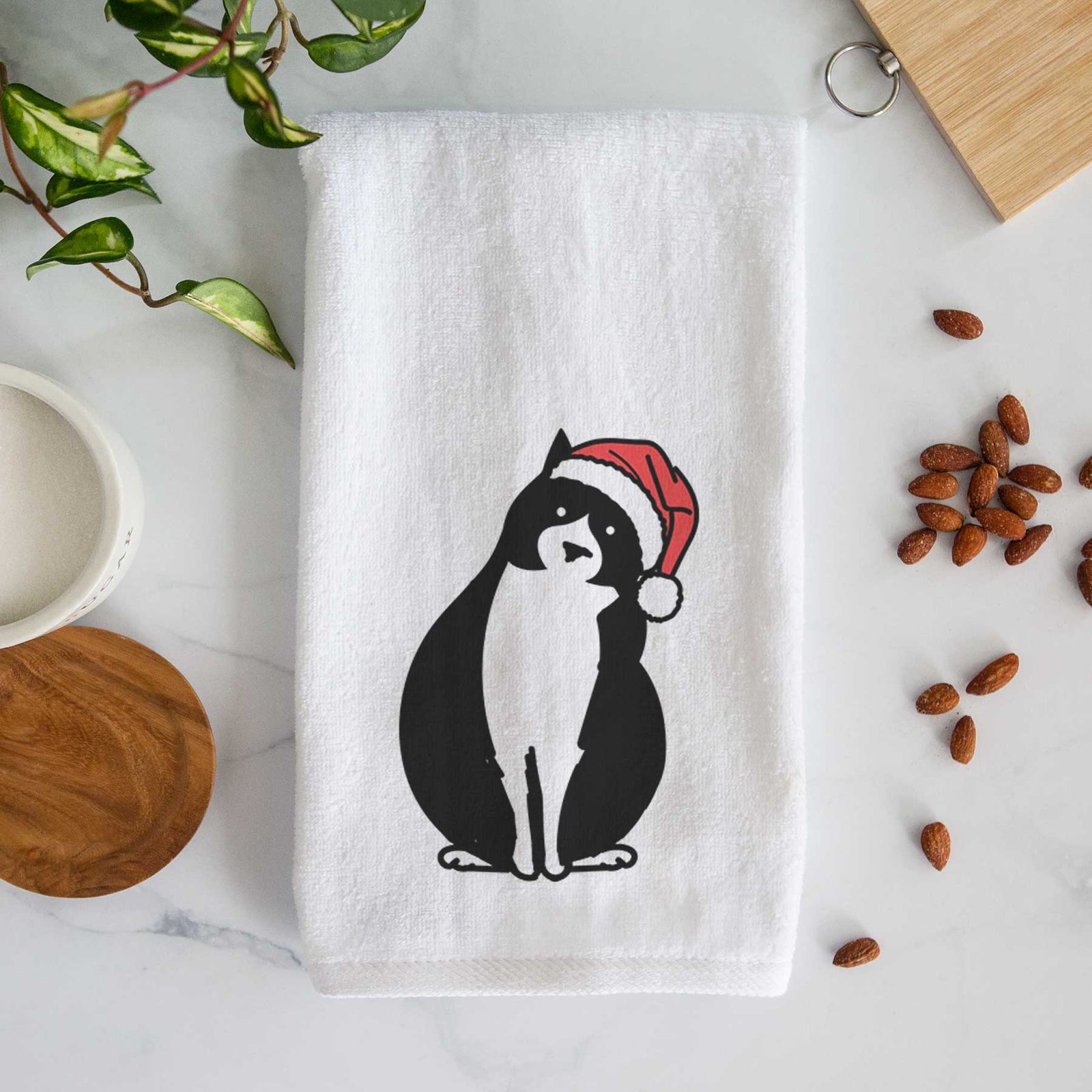 Minimalist line drawing of Oliver the Tuxedo Cat wearing a Santa hat on a decorative hand towel