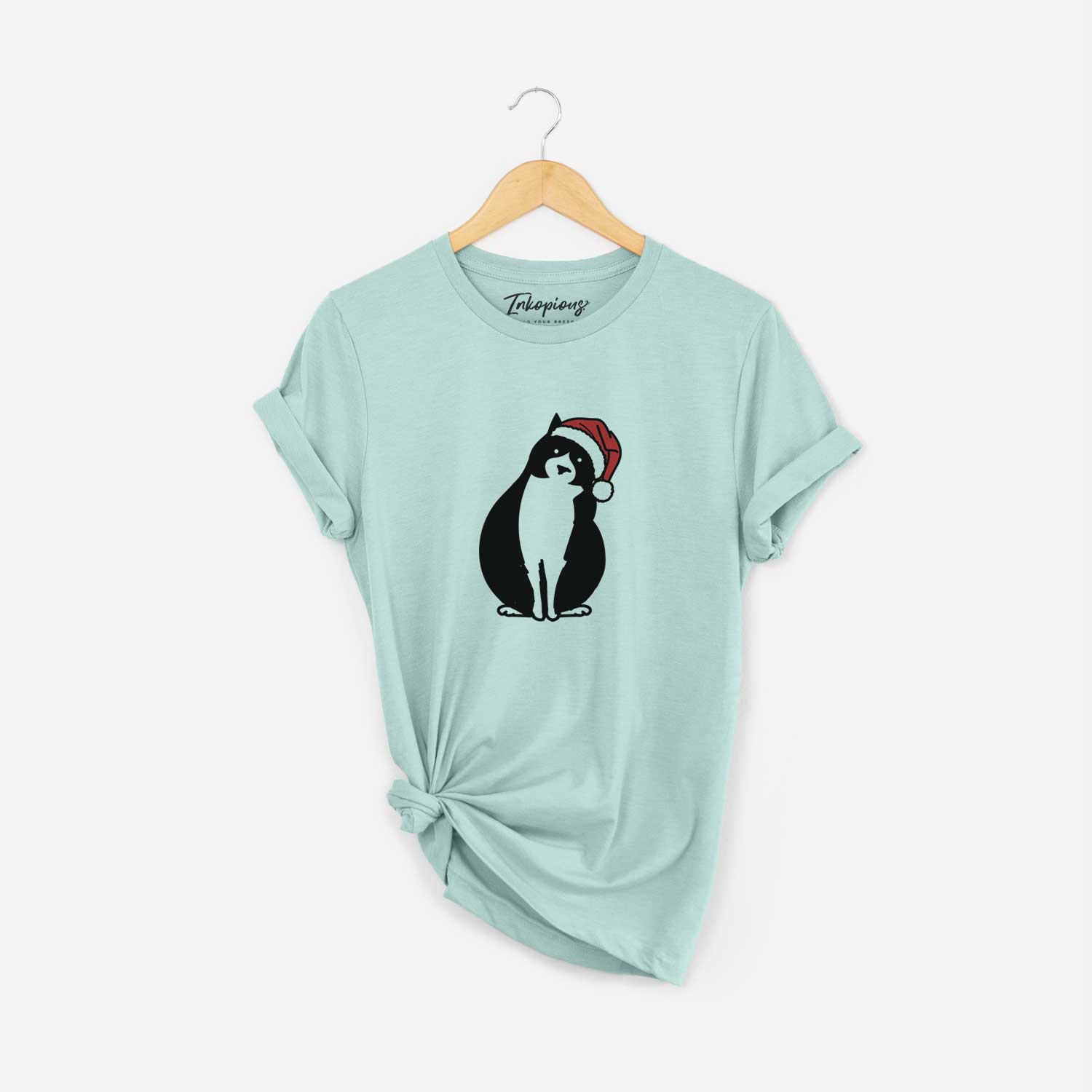 Minimalist line drawing of Oliver the Tuxedo Cat wearing a Santa hat on a Heather Sage Unisex crewneck