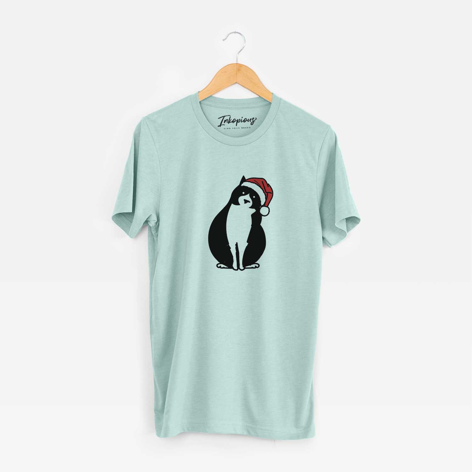 Minimalist line drawing of Oliver the Tuxedo Cat wearing a Santa hat on a Heather Sage Unisex crewneck