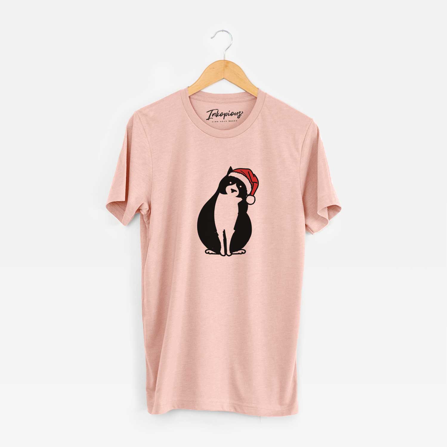 Minimalist line drawing of Oliver the Tuxedo Cat wearing a Santa hat on a Peach Unisex crewneck