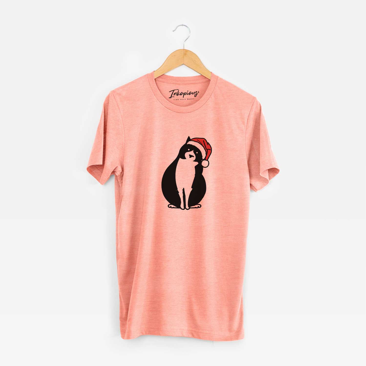Minimalist line drawing of Oliver the Tuxedo Cat wearing a Santa hat on a Sunset Unisex crewneck