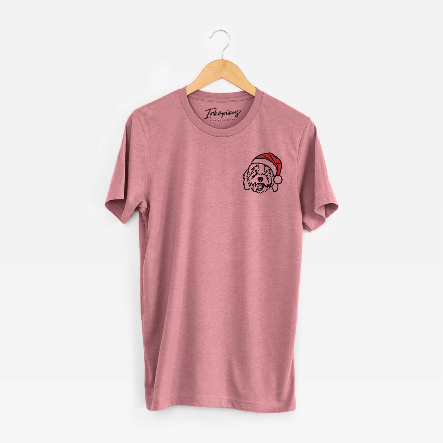 Small chest-pocket minimalist line drawing of Barry the Goldendoodle wearing a Santa hat on a Mauve Unisex crewneck
