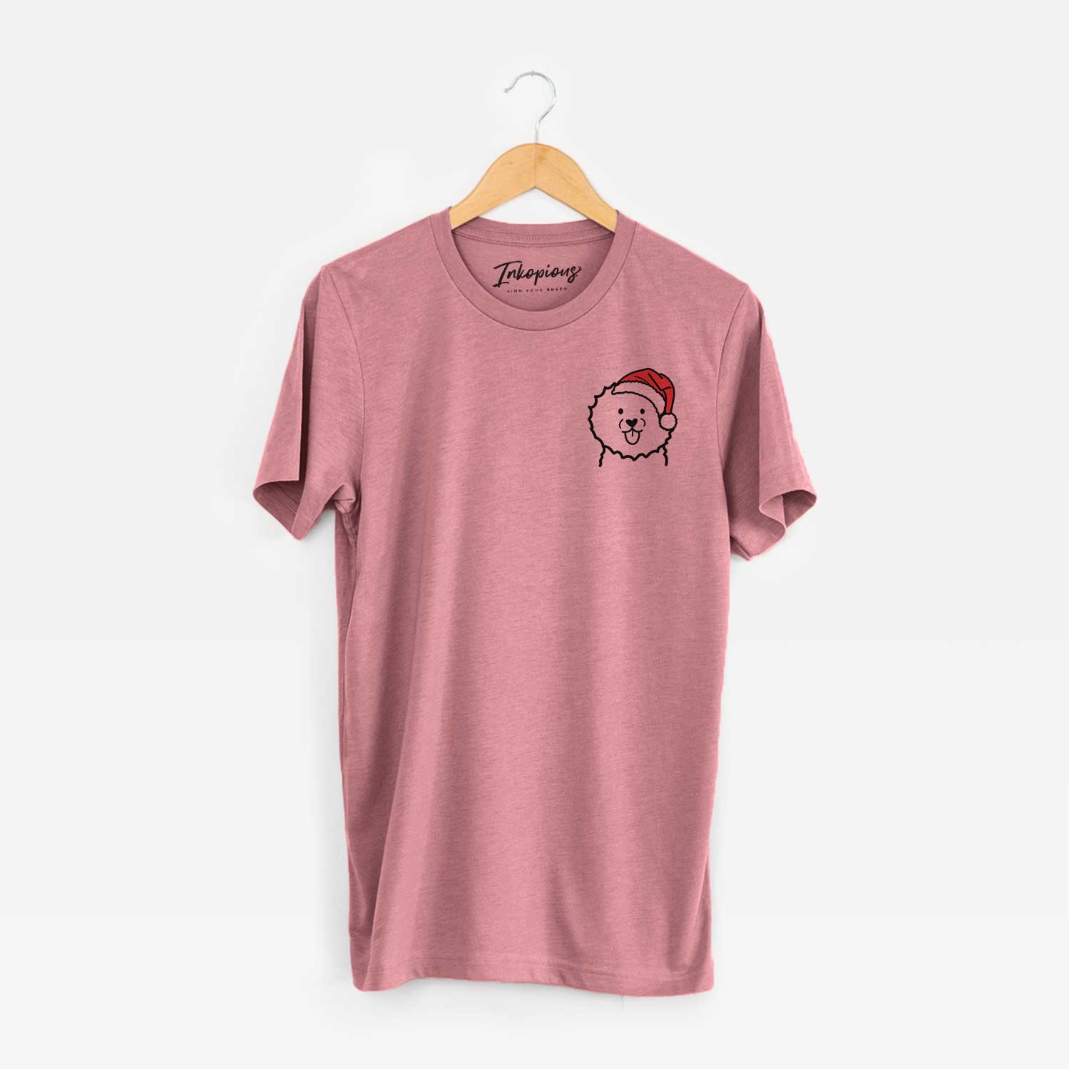 Small chest-pocket minimalist line drawing of a Bichon Frise wearing a Santa hat on a Mauve Unisex crewneck