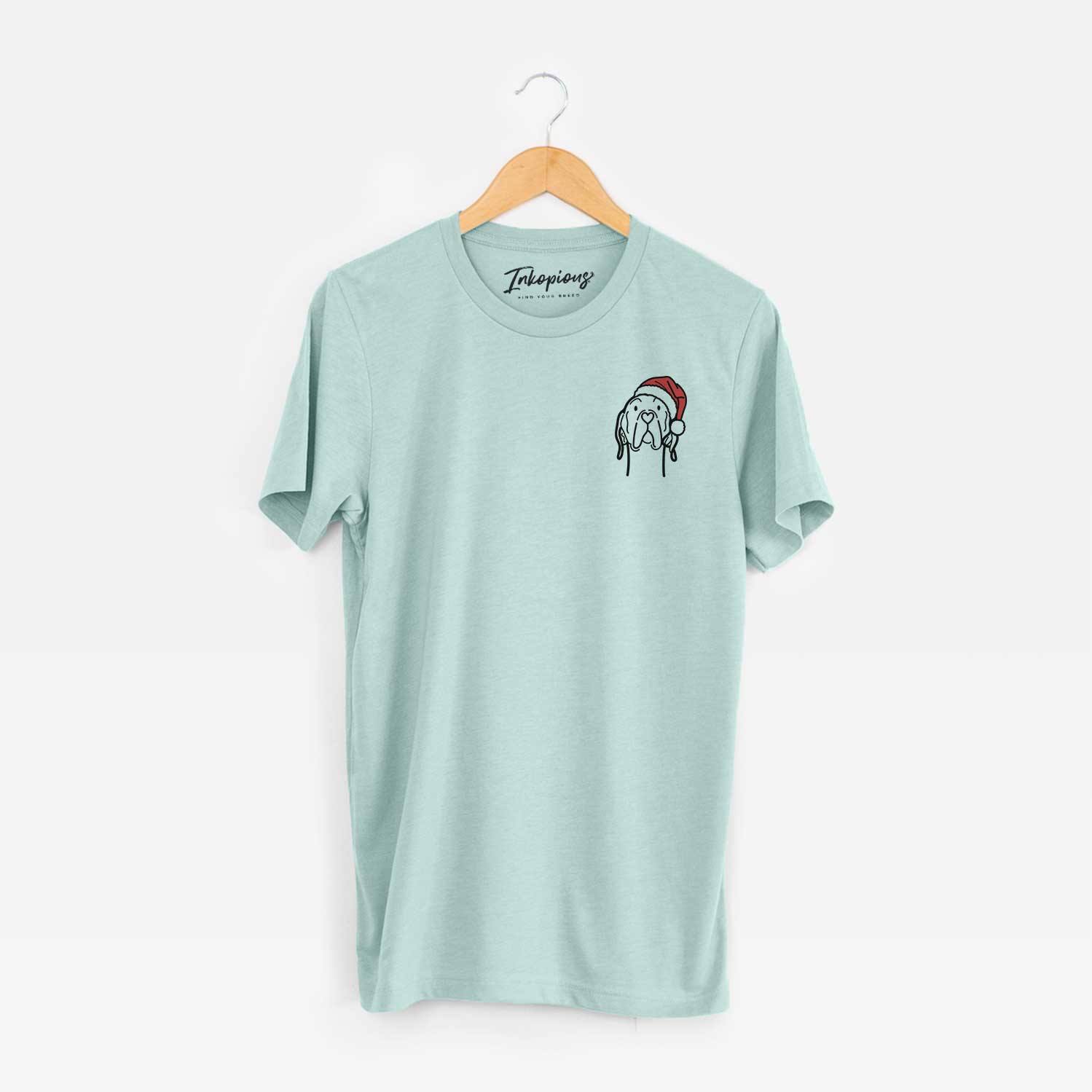 Small chest-pocket minimalist line drawing of an English Pointer wearing a Santa hat on a Heather Sage Unisex crewneck