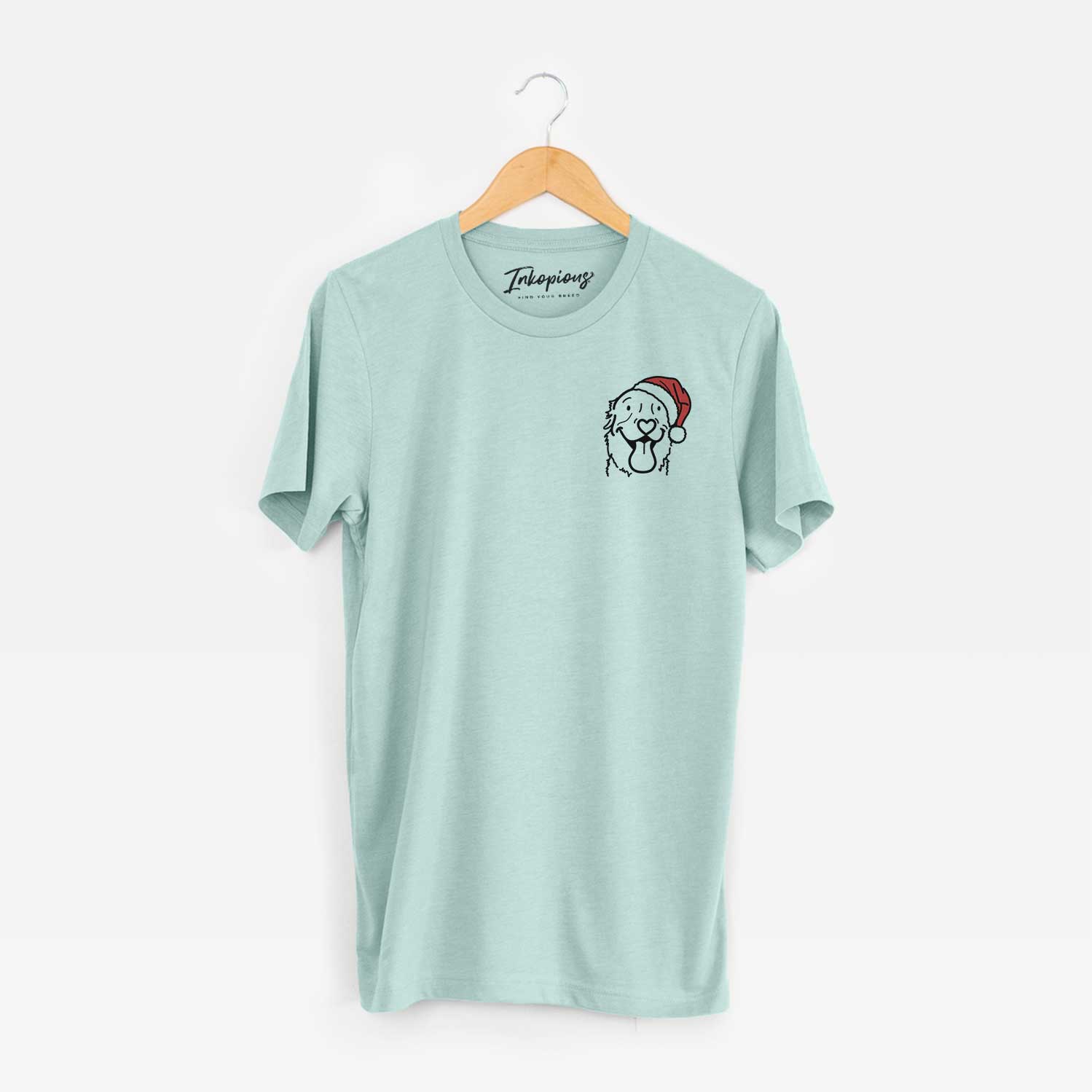 Small chest-pocket minimalist line drawing of Maple the Golden Retriever wearing a Santa hat on a Heather Sage Unisex crewneck
