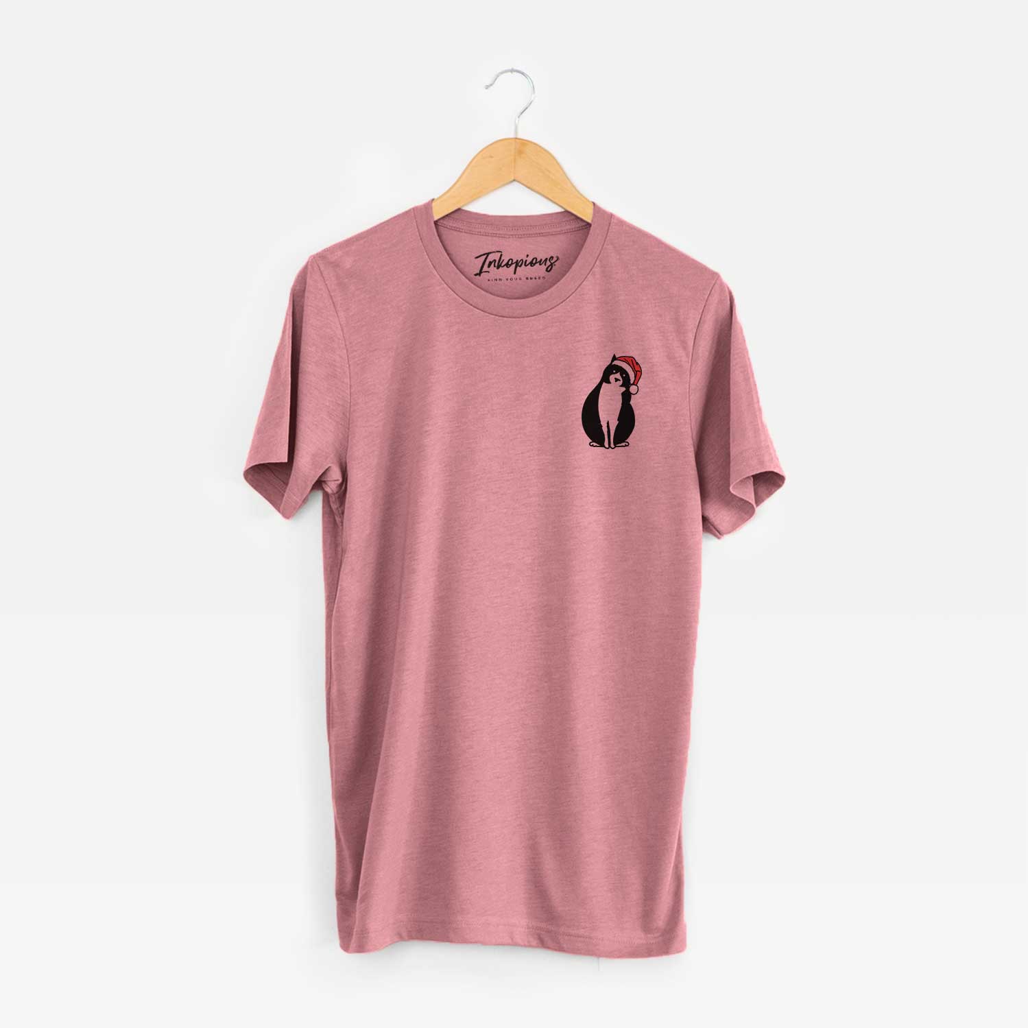 Small chest-pocket minimalist line drawing of Oliver the Tuxedo Cat wearing a Santa hat on a Mauve Unisex crewneck