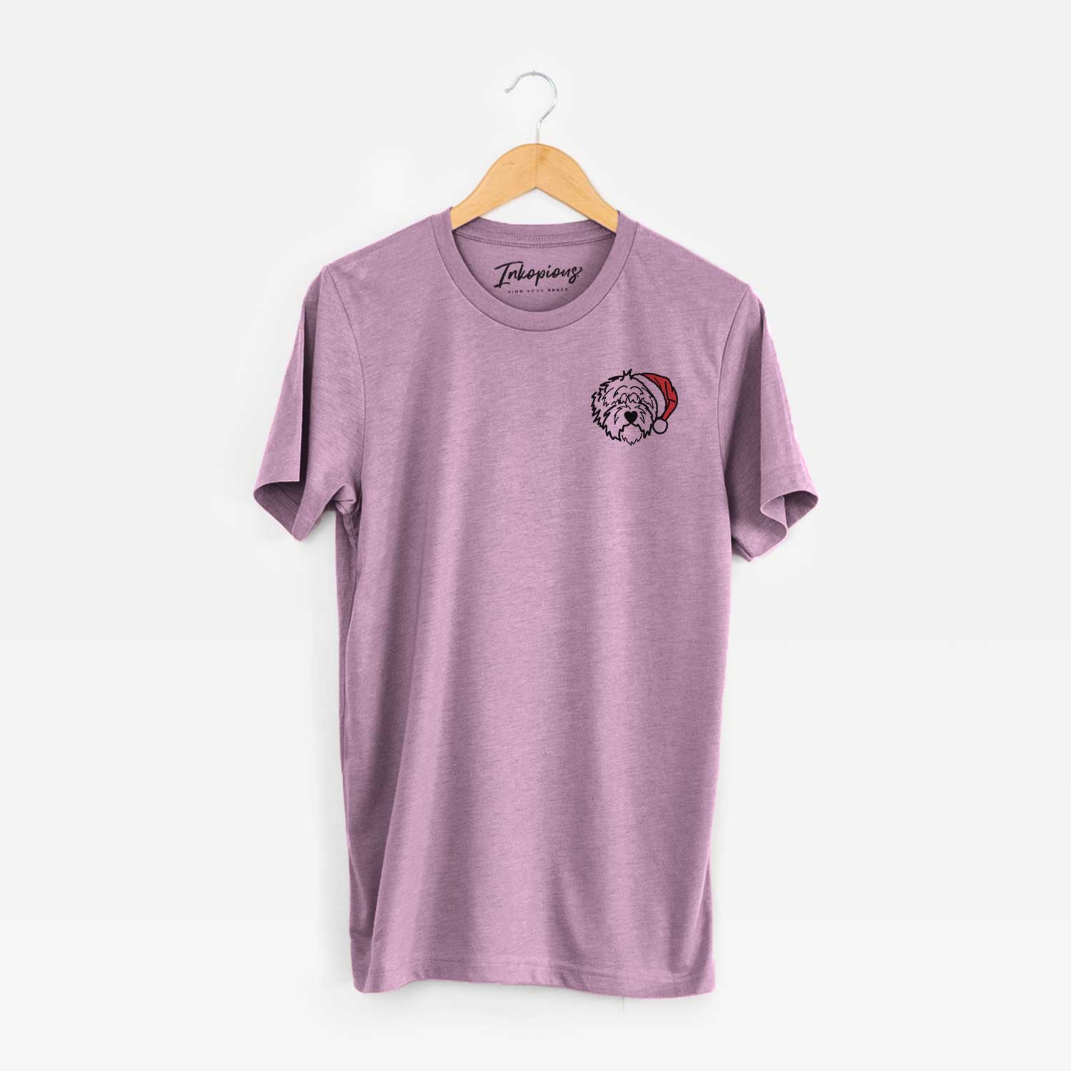 Small chest-pocket minimalist line drawing of Penny the Old English Sheepdog wearing a Santa hat on an Orchid Unisex crewneck