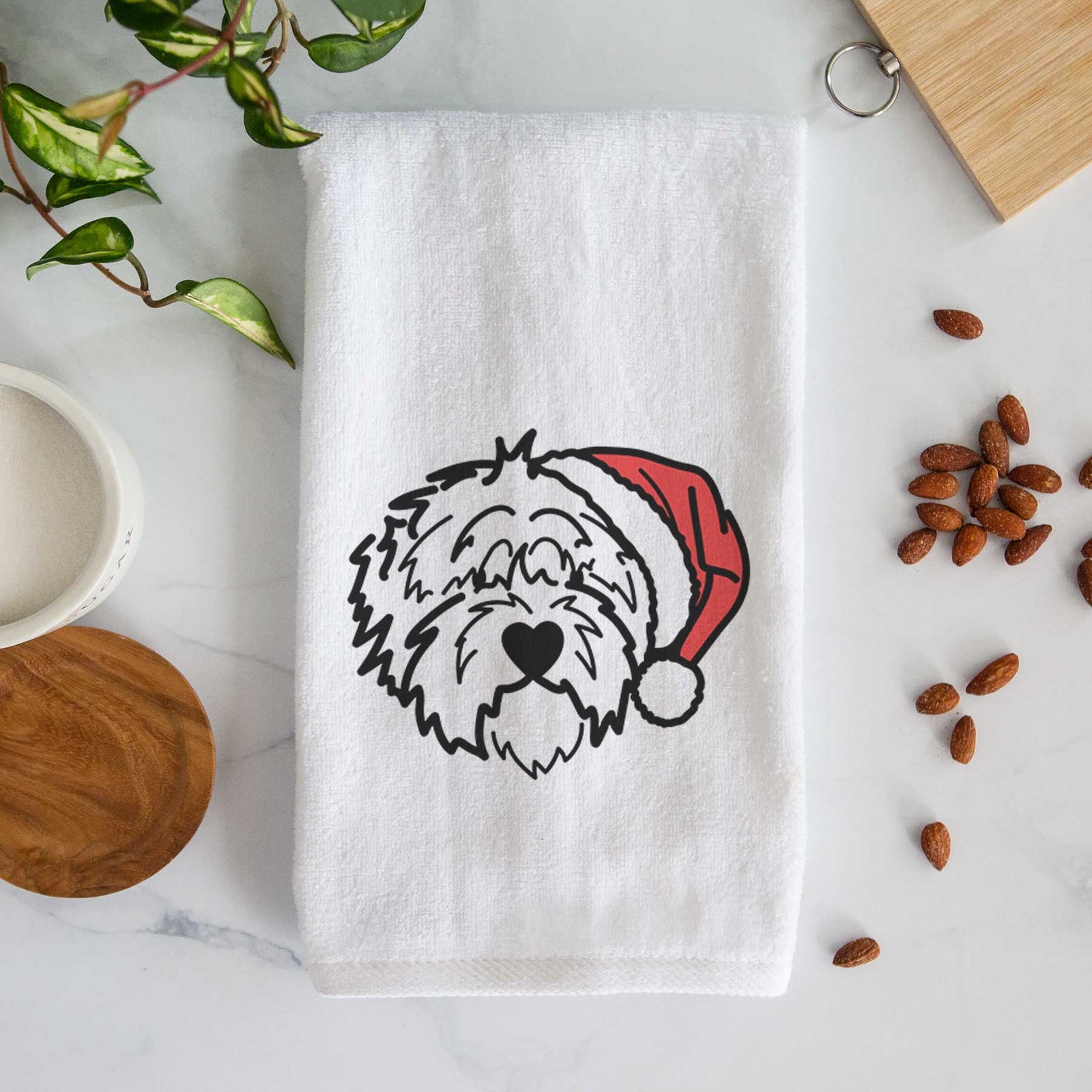Minimalist line drawing of Penny the Old English Sheepdog wearing a Santa hat on a decorative hand towel