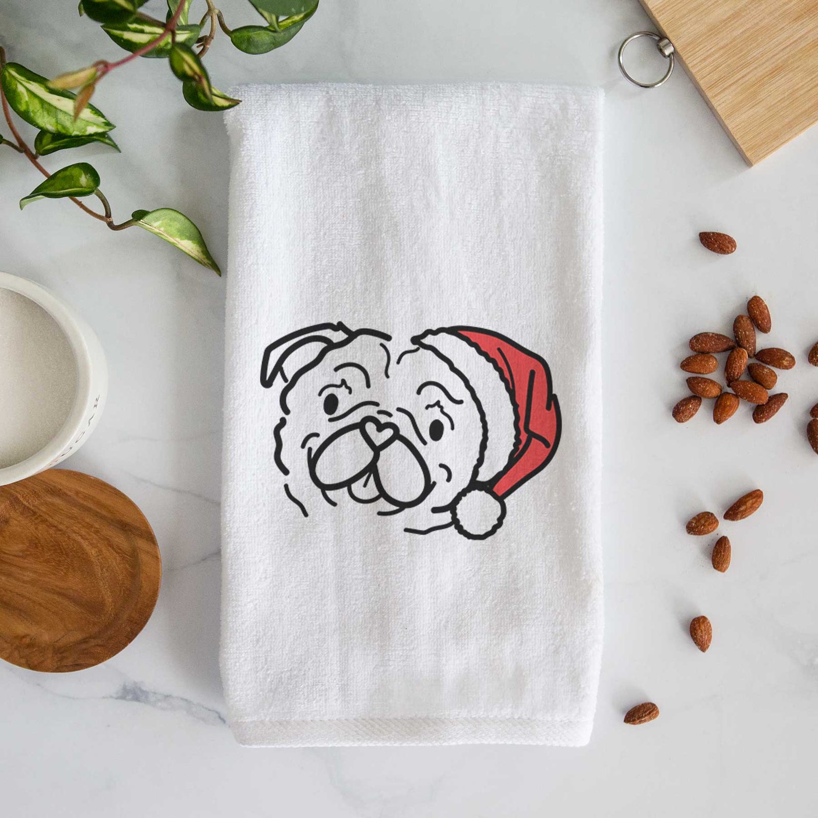 Minimalist line drawing of Pip the Pug wearing a Santa hat on a decorative hand towel