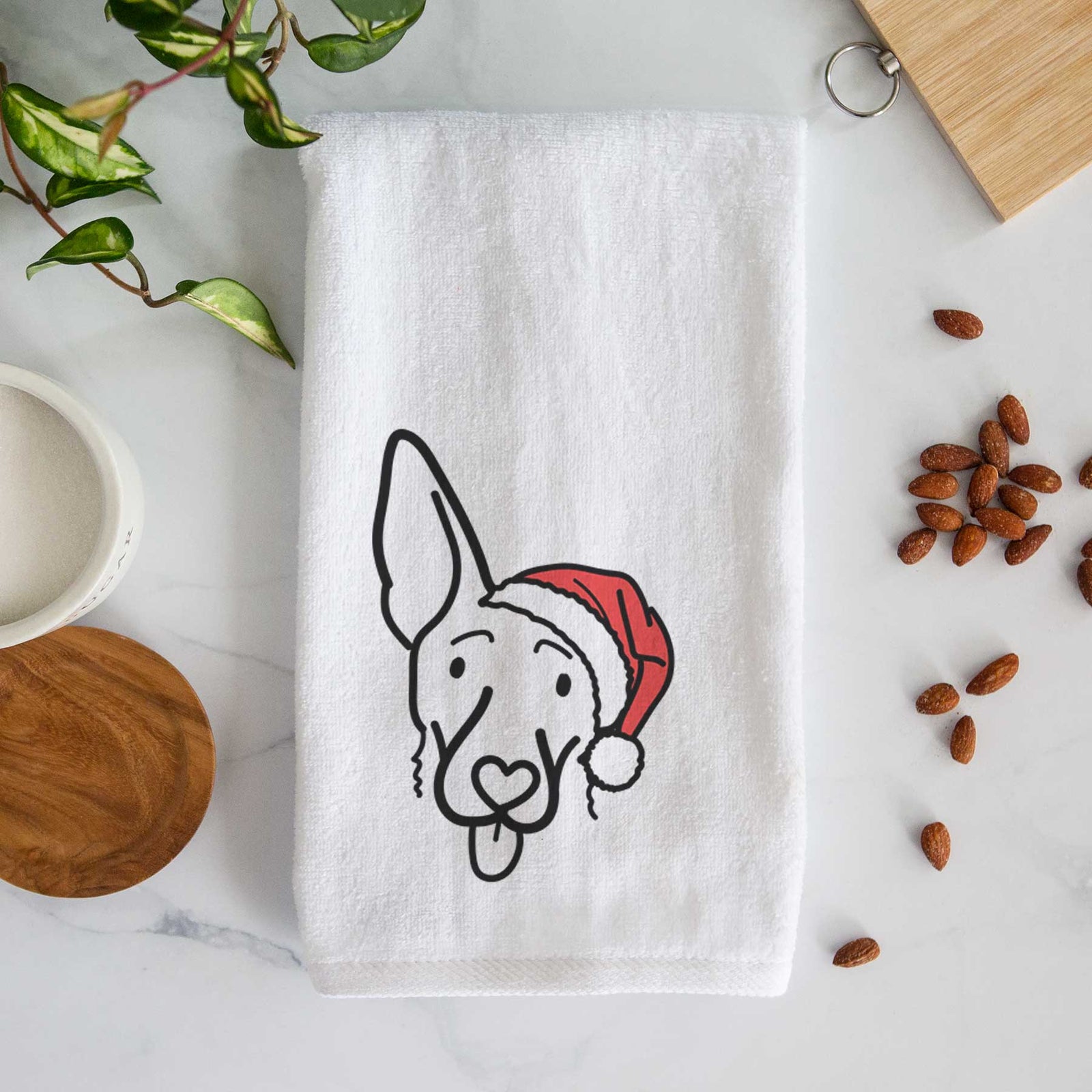 Minimalist line drawing of Rosie the Shepherd Mix wearing a Santa hat on a decorative hand towel