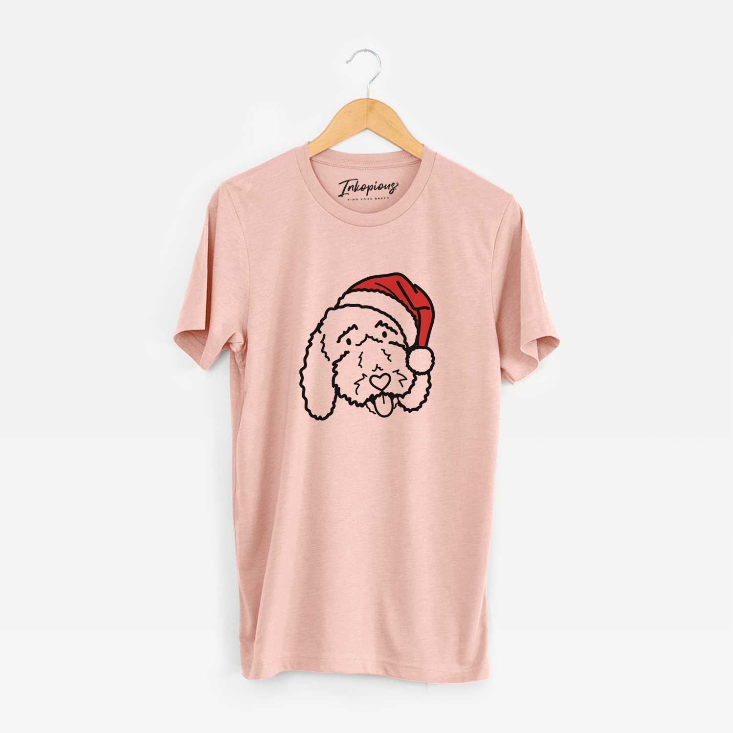 Minimalist line drawing of Ruby the Bernedoodle wearing a Santa hat on a Peach Unisex crewneck