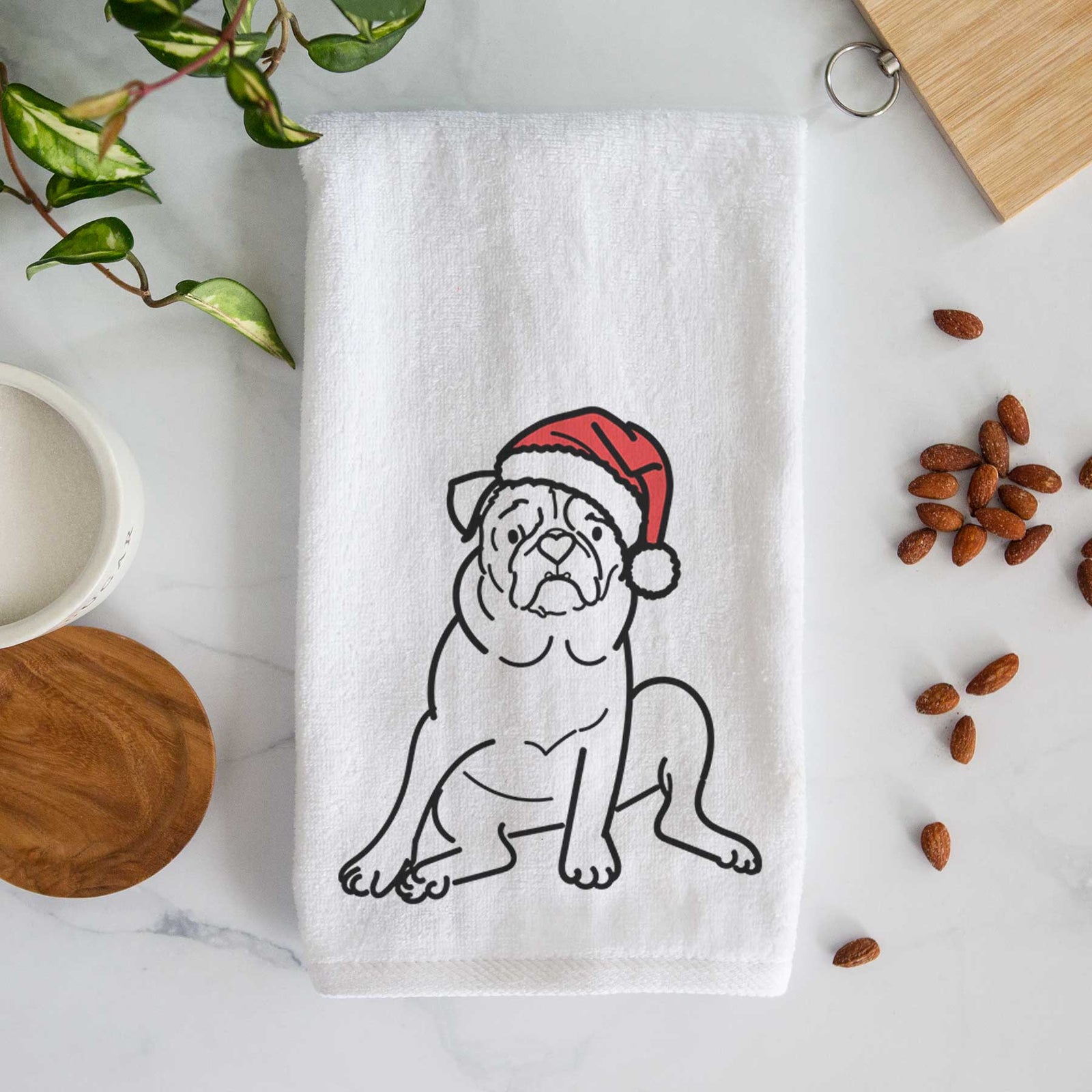 Minimalist line drawing of Rudy the Pug wearing a Santa hat on a decorative hand towel