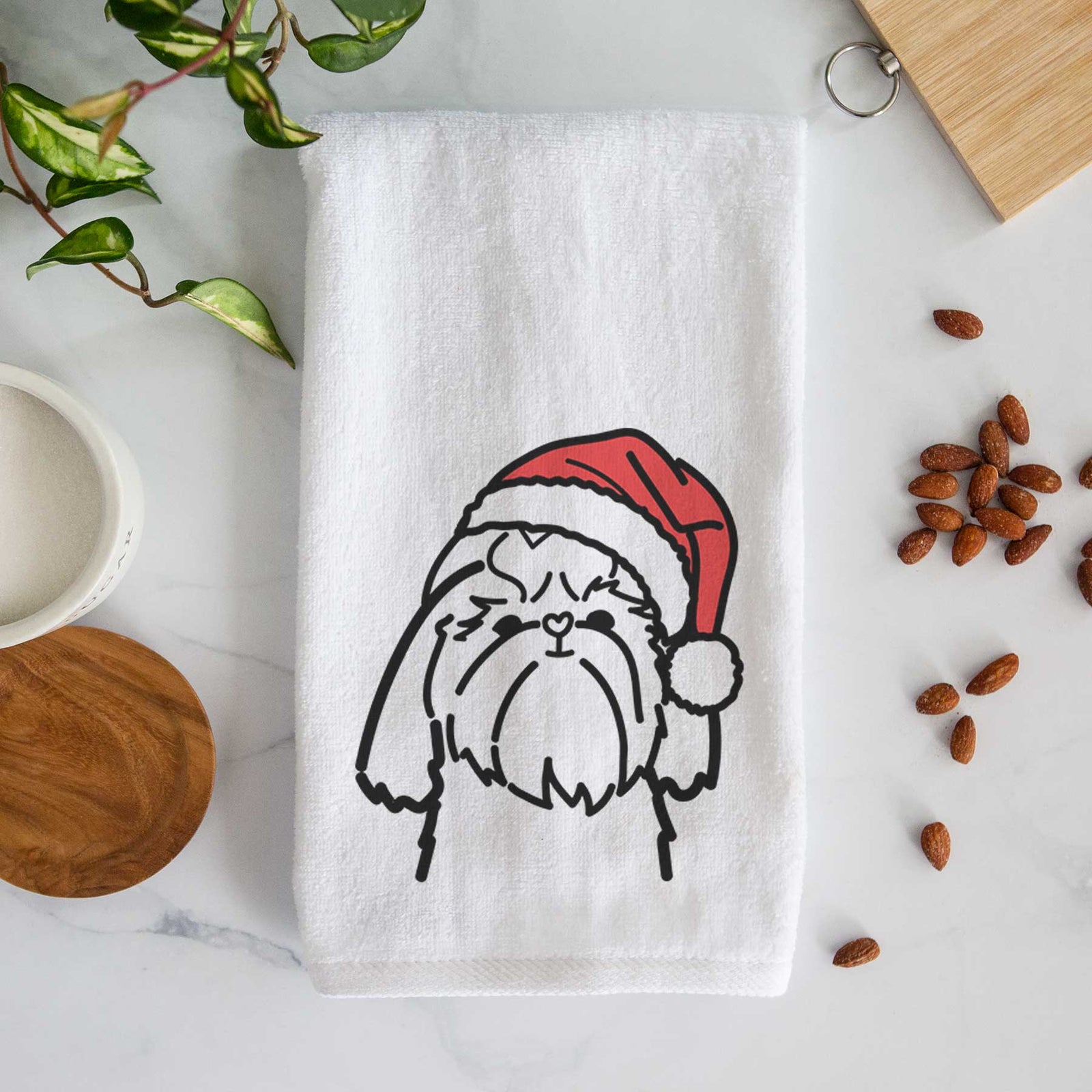 Minimalist line drawing of a Shih Tzu wearing a Santa hat on a decorative hand towel