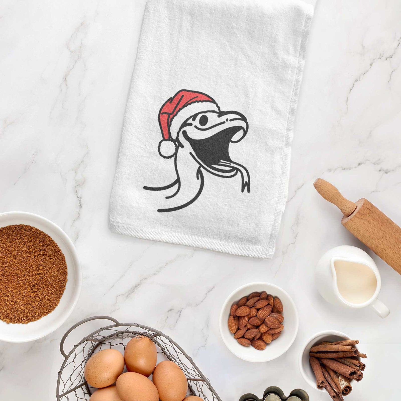 Minimalist line drawing of Spike the Snake wearing a Santa hat on a decorative hand towel