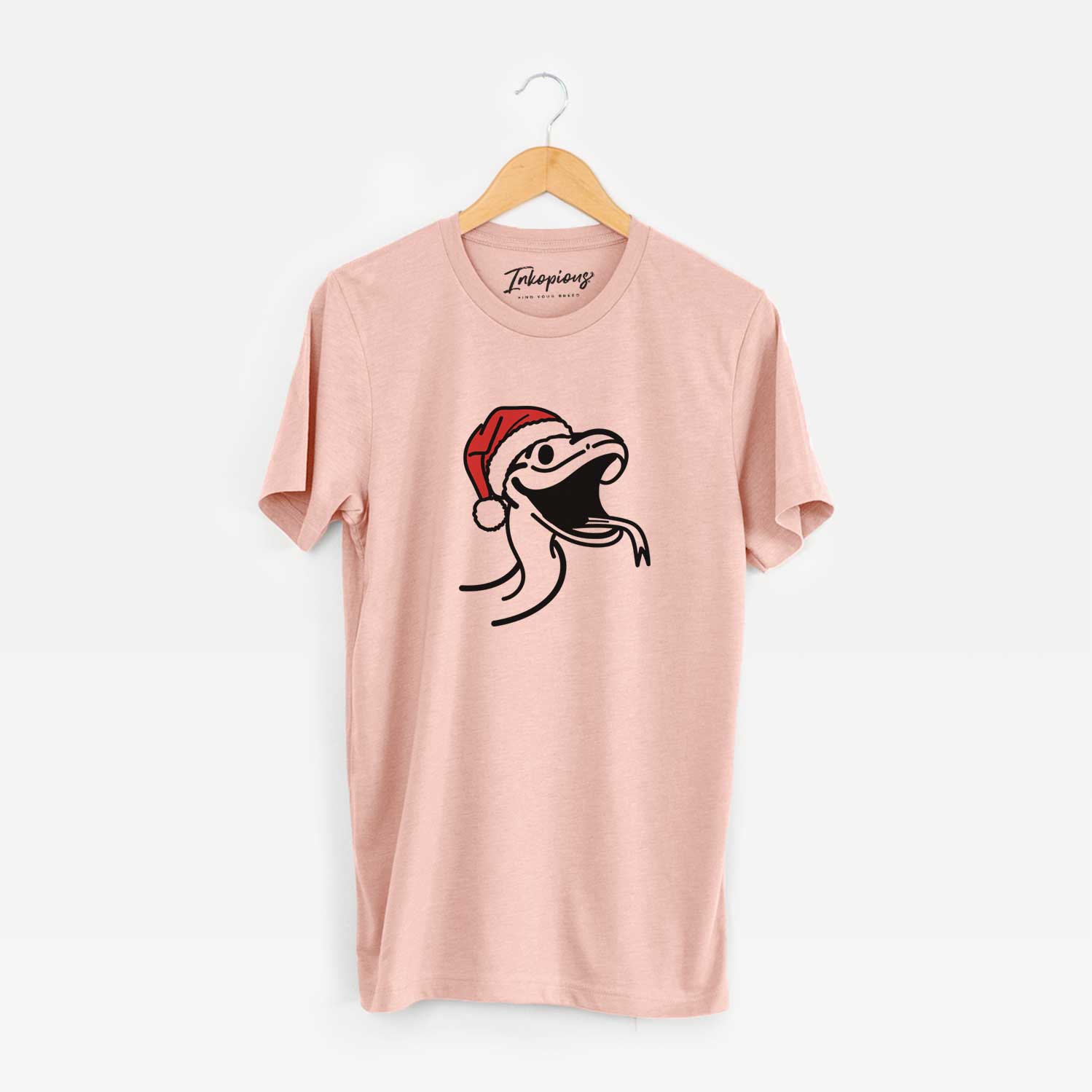Minimalist line drawing of Spike the Snake wearing a Santa hat on a Peach Unisex crewneck