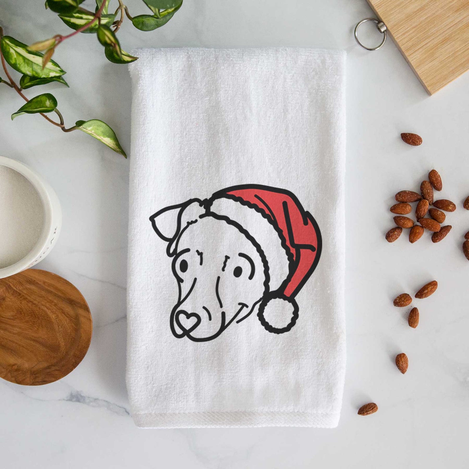 Minimalist line drawing of Tater Tot the Chiweenie wearing a Santa hat on a decorative hand towel