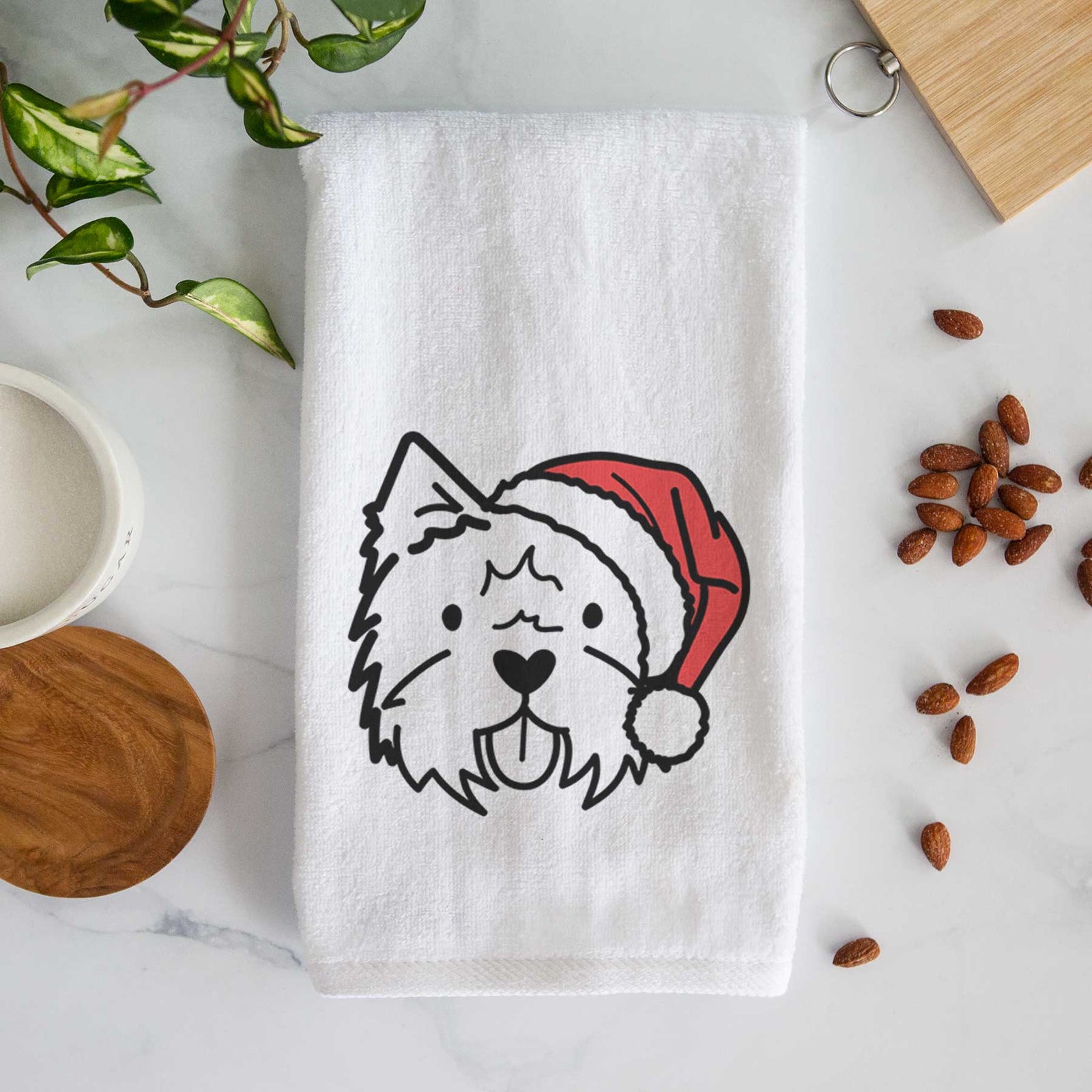 Minimalist line drawing of a West Highland Terrier wearing a Santa hat on a decorative hand towel