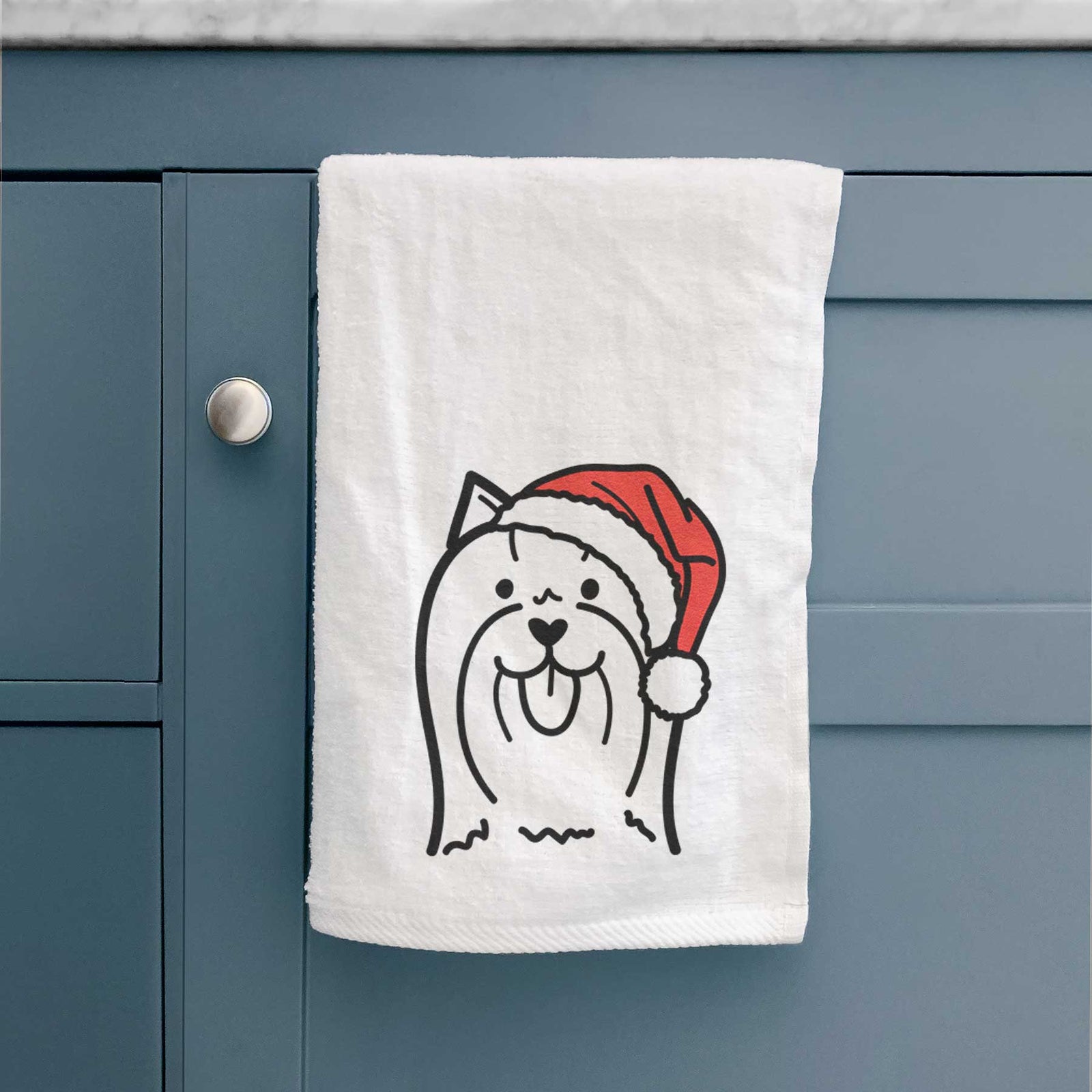 Minimalist line drawing of a Yorkshire Terrier wearing a Santa hat on a decorative hand towel