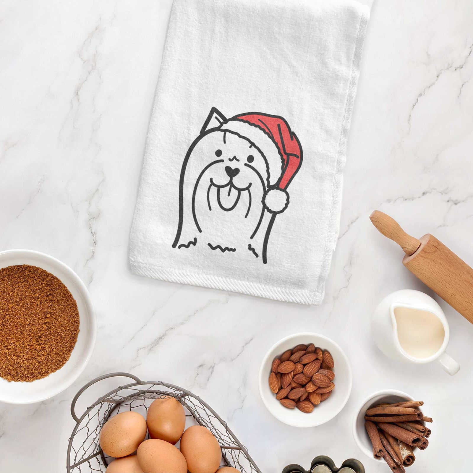 Minimalist line drawing of a Yorkshire Terrier wearing a Santa hat on a decorative hand towel