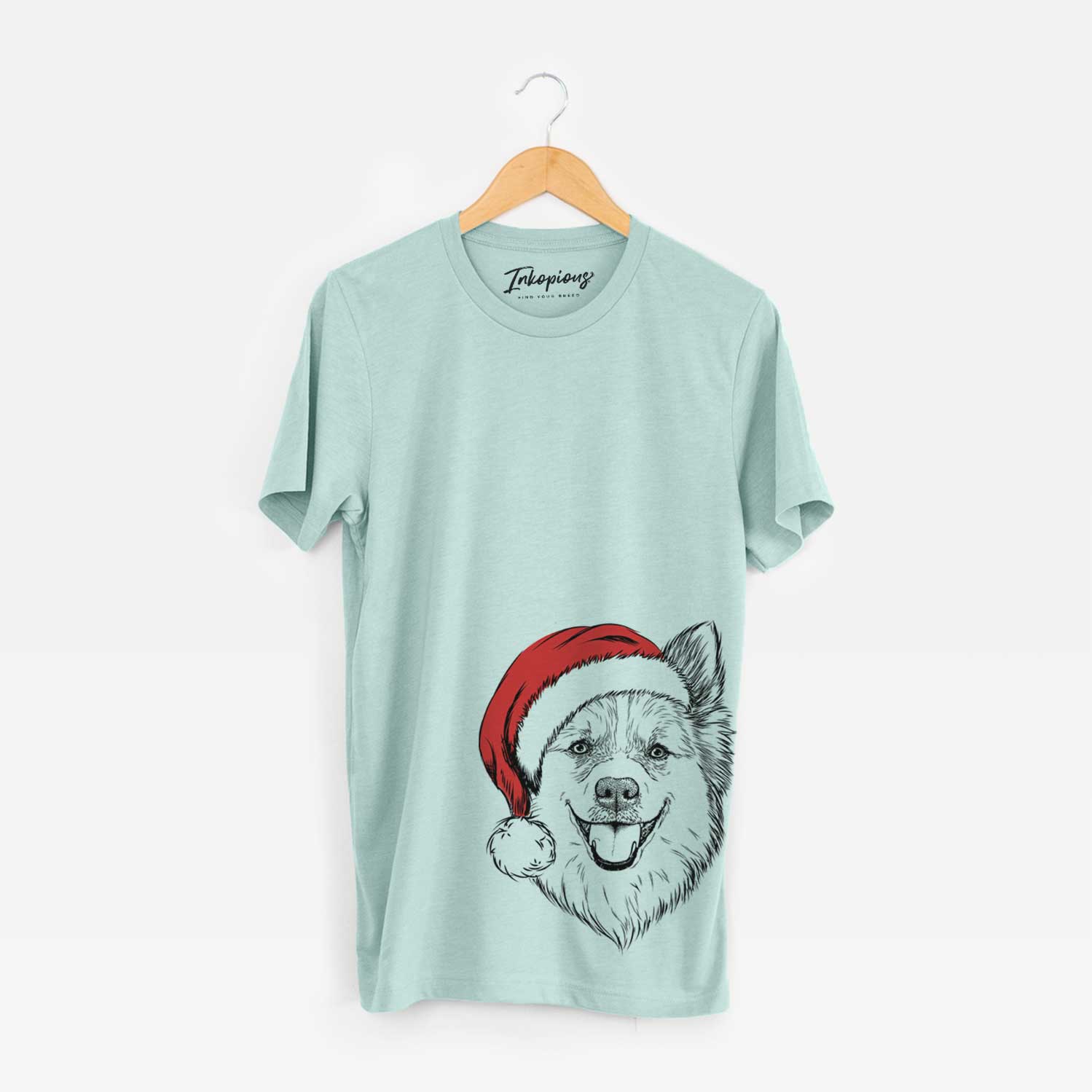Hand-drawn sketch of Ari the Icelandic Sheepdog wearing a Santa hat on a Heather Sage Unisex crewneck