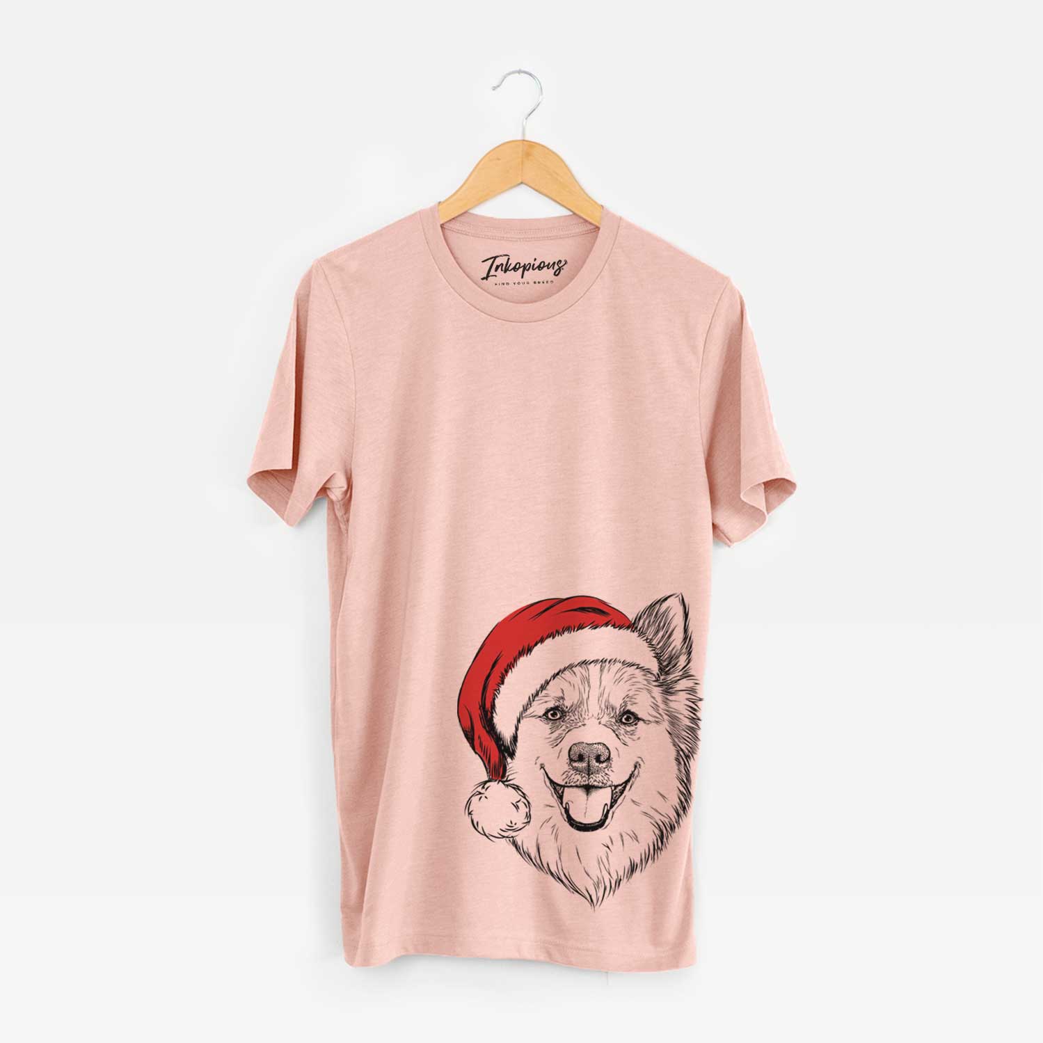 Hand-drawn sketch of Ari the Icelandic Sheepdog wearing a Santa hat on a Peach Unisex crewneck