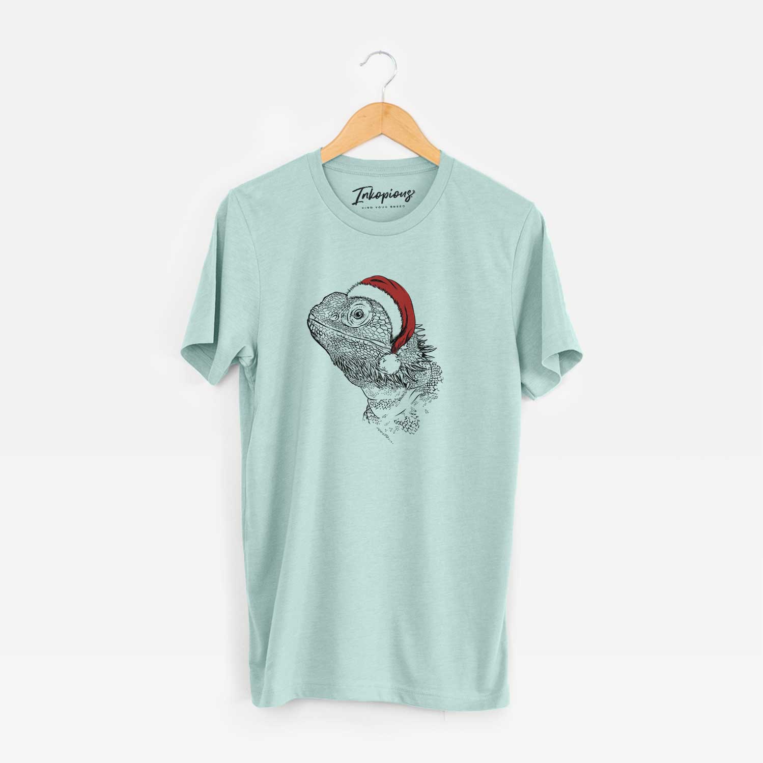 Hand-drawn sketch of Ash the Bearded Dragon wearing a Santa hat on a Heather Sage Unisex crewneck