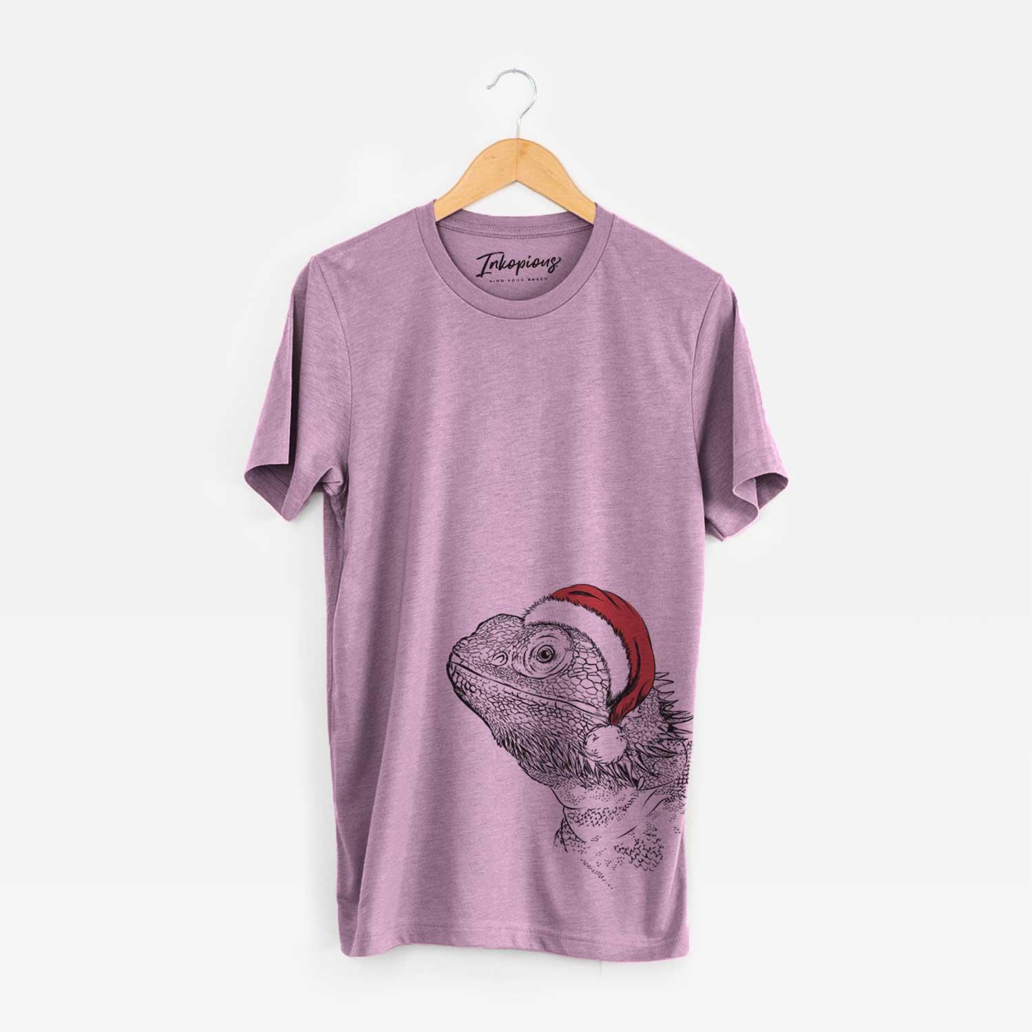 Hand-drawn sketch of Ash the Bearded Dragon wearing a Santa hat on an Orchid Unisex crewneck