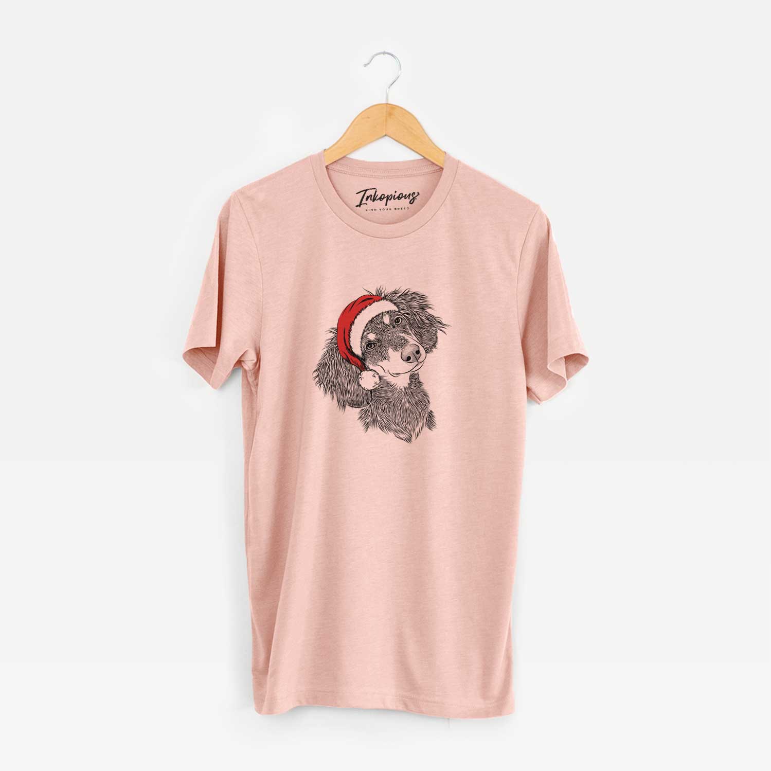 Hand-drawn sketch of Bailey the Long Haired Dachshund wearing a Santa hat on a Peach Unisex crewneck