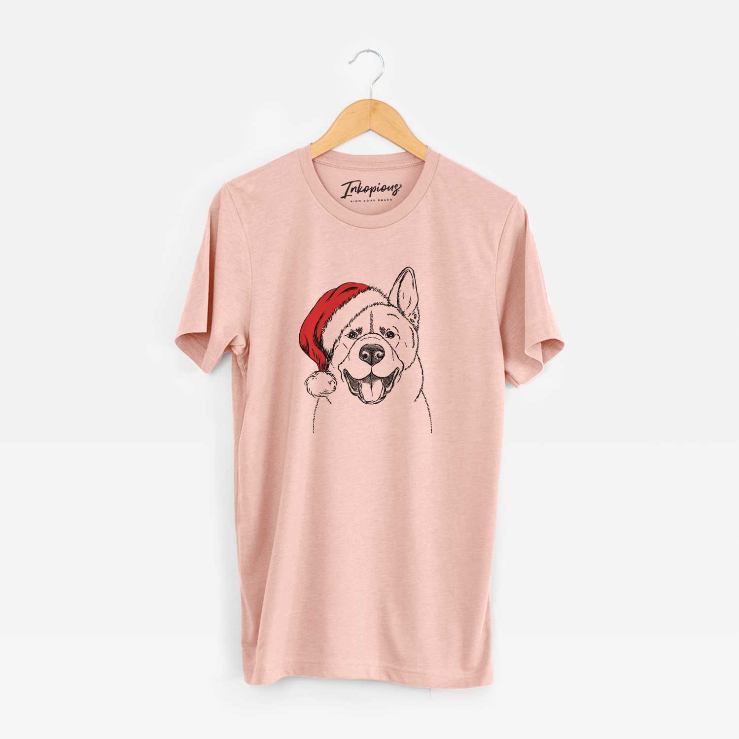Hand-drawn sketch of Baku the Akita wearing a Santa hat on a Peach Unisex crewneck