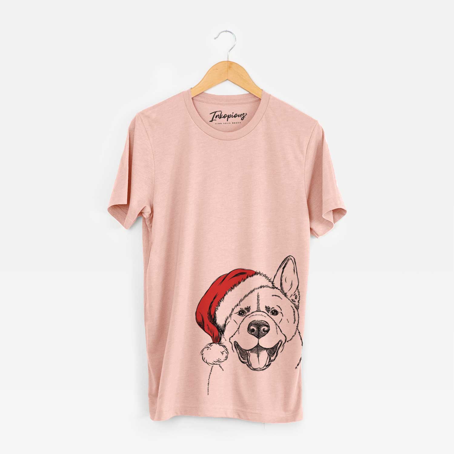 Hand-drawn sketch of Baku the Akita wearing a Santa hat on a Peach Unisex crewneck