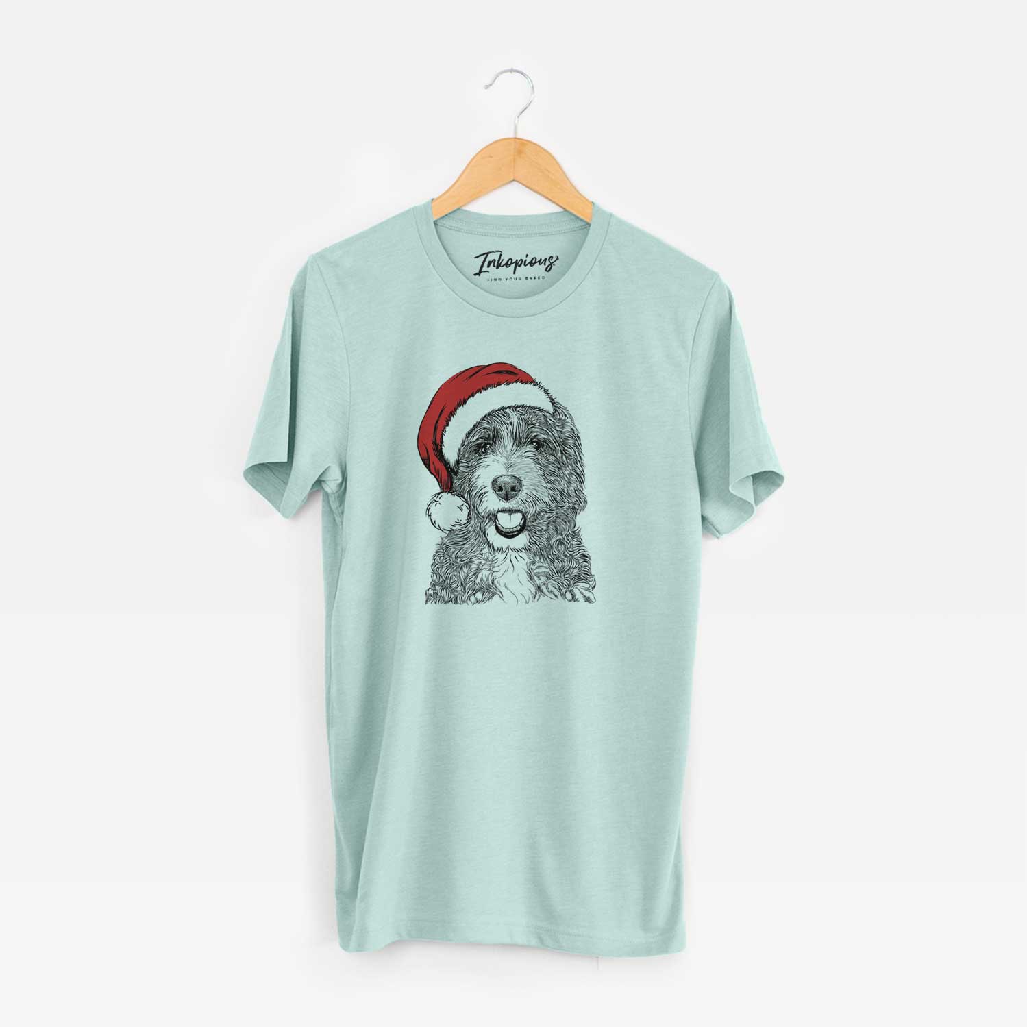 Hand-drawn sketch of Bash the Bernedoodle wearing a Santa hat on a Heather Sage Unisex crewneck