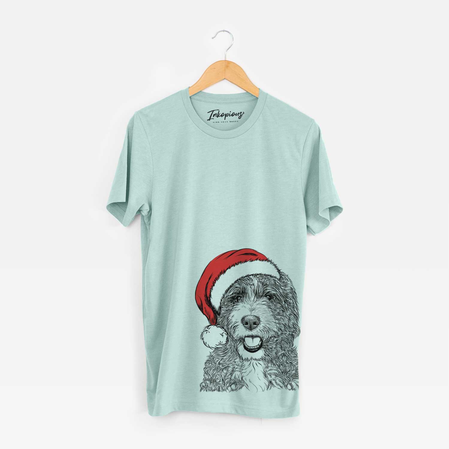 Hand-drawn sketch of Bash the Bernedoodle wearing a Santa hat on a Heather Sage Unisex crewneck