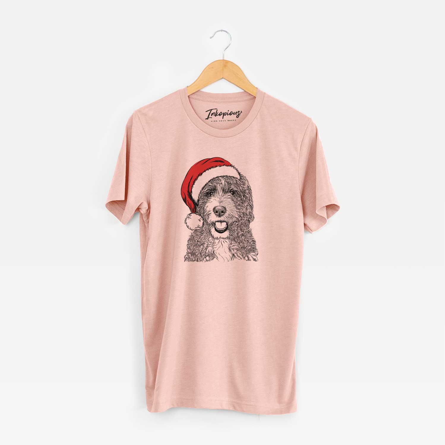 Hand-drawn sketch of Bash the Bernedoodle wearing a Santa hat on a Peach Unisex crewneck