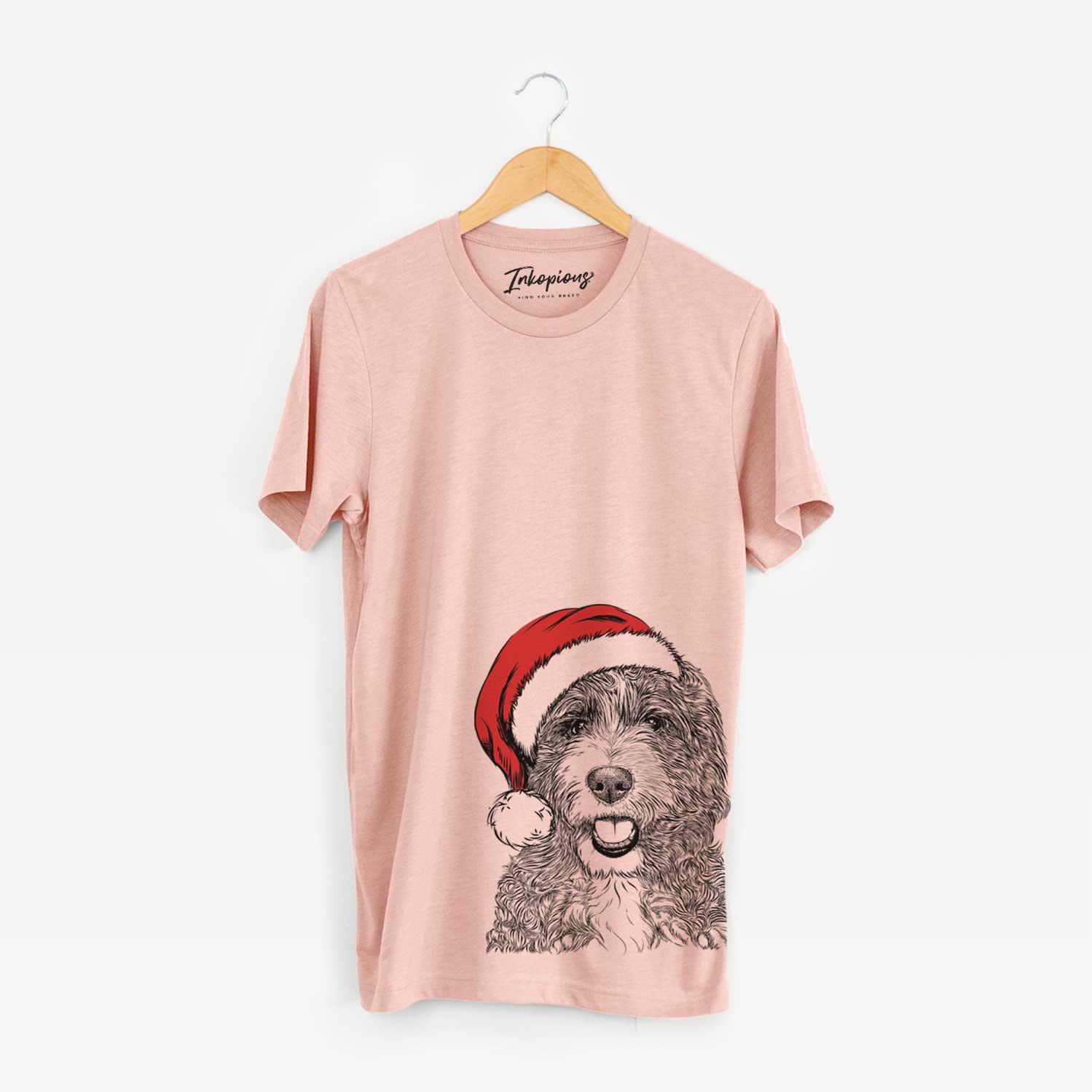 Hand-drawn sketch of Bash the Bernedoodle wearing a Santa hat on a Peach Unisex crewneck