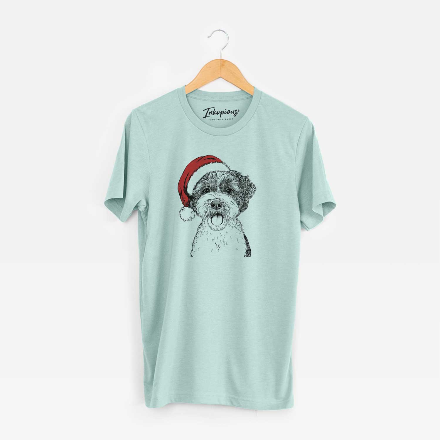 Hand-drawn sketch of Bella the Cockapoo wearing a Santa hat on a Heather Sage Unisex crewneck