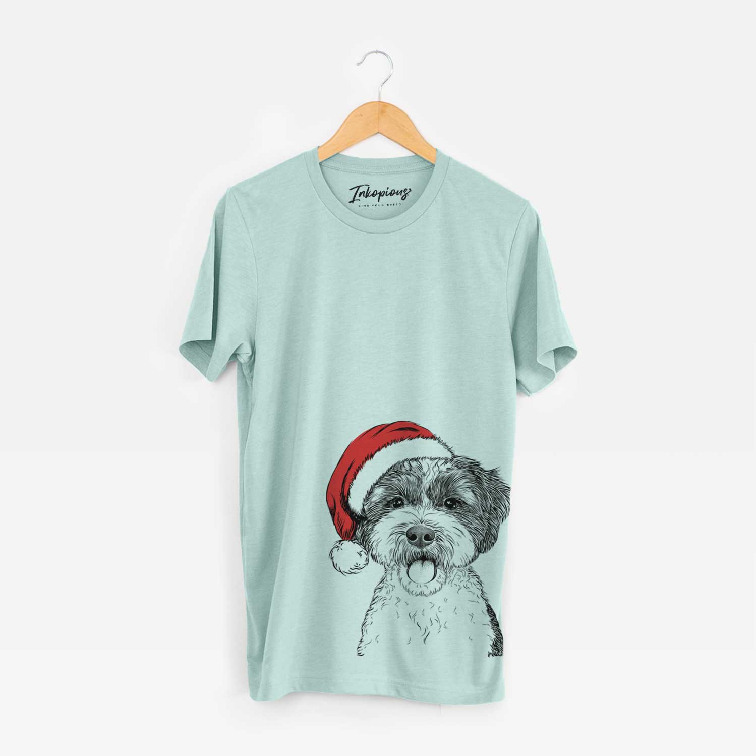 Hand-drawn sketch of Bella the Cockapoo wearing a Santa hat on a Heather Sage Unisex crewneck