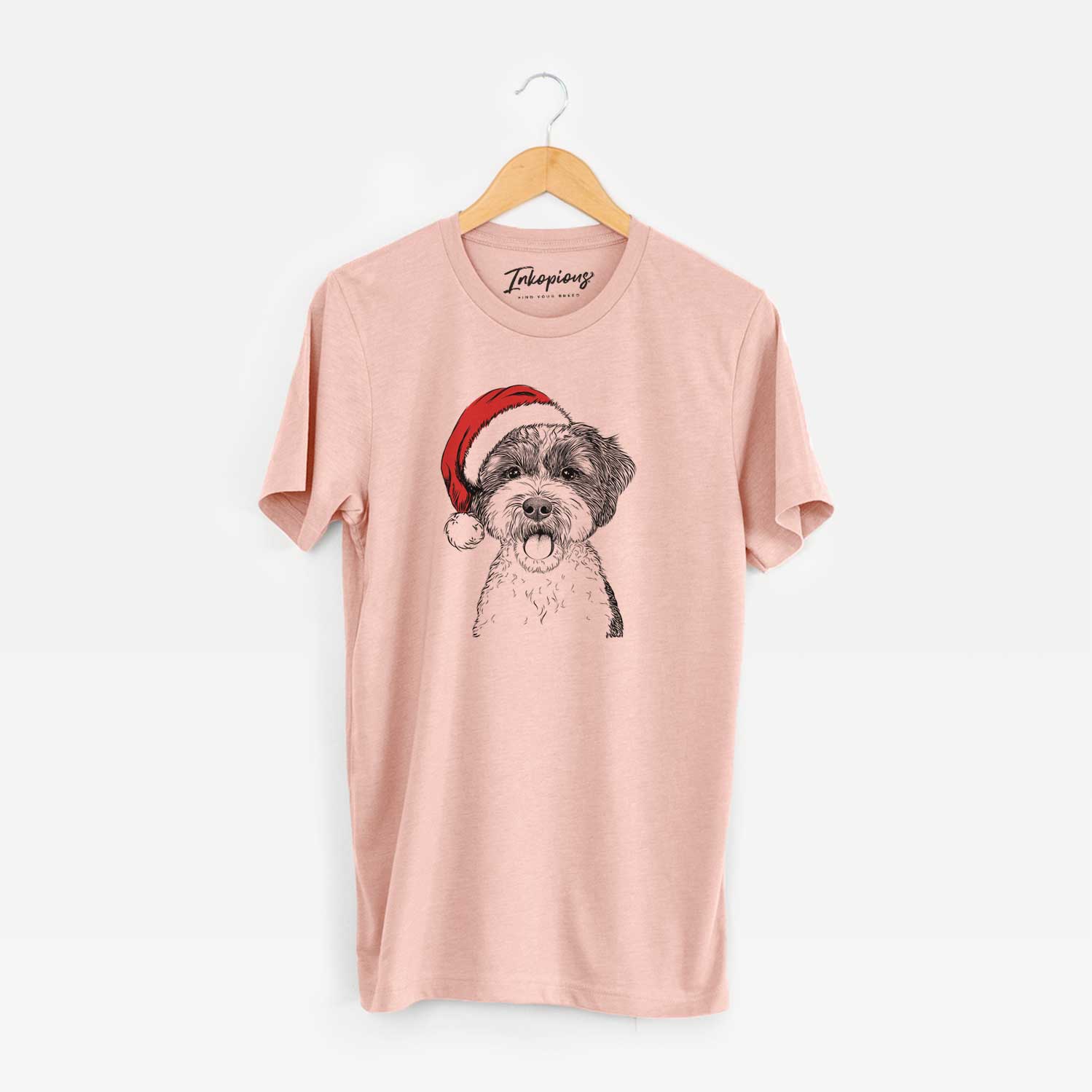 Hand-drawn sketch of Bella the Cockapoo wearing a Santa hat on a Peach Unisex crewneck