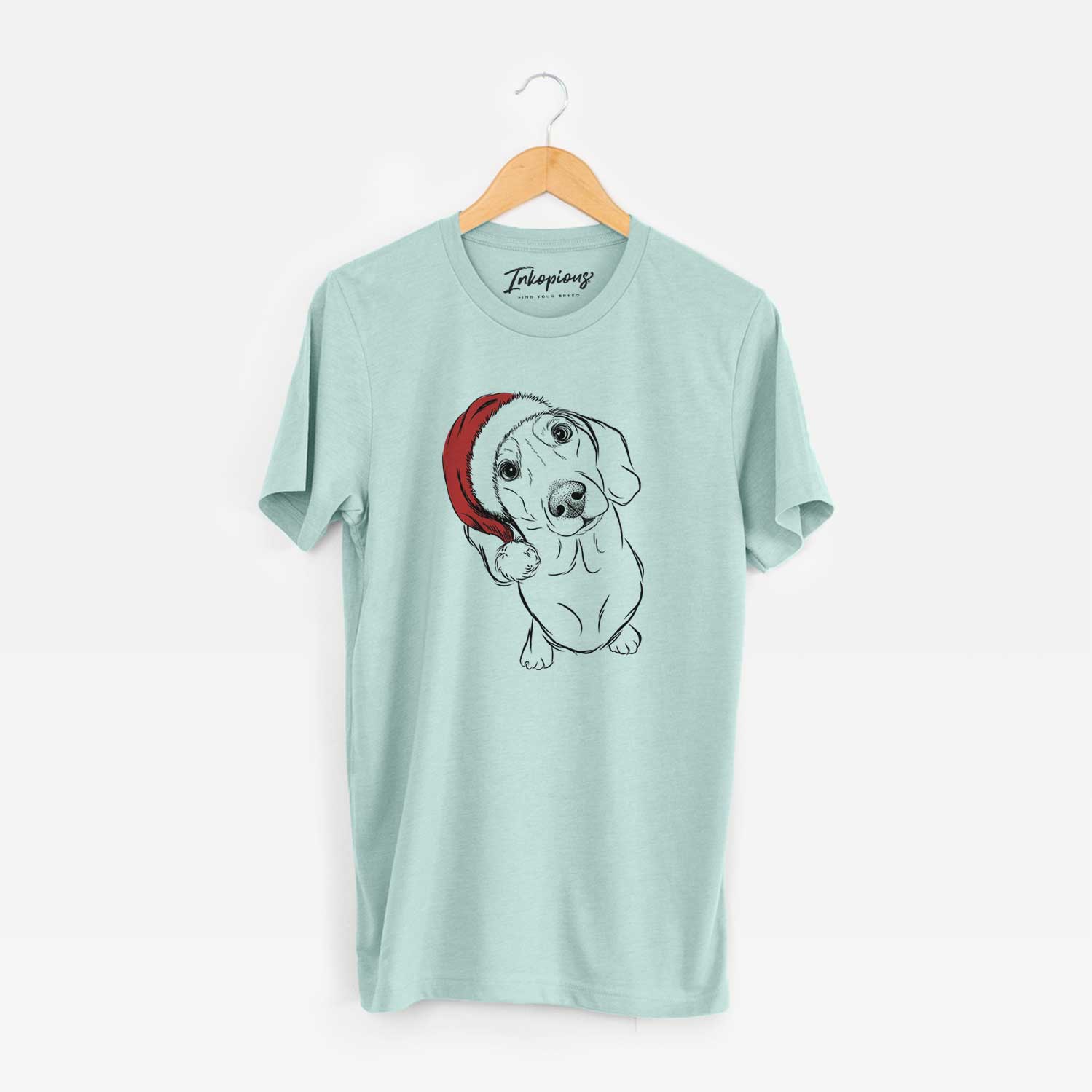 Hand-drawn sketch of Bill the Dachshund wearing a Santa hat on a Heather Sage Unisex crewneck