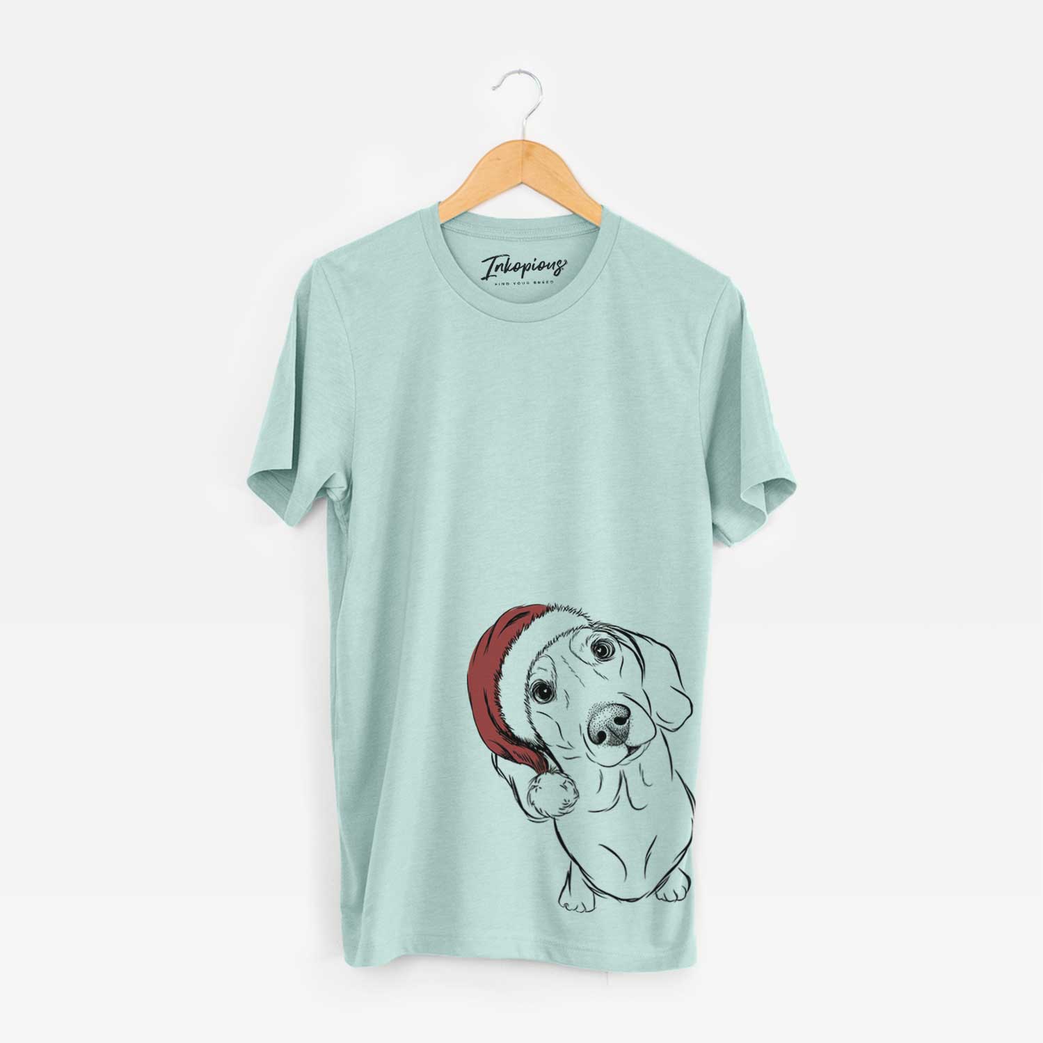 Hand-drawn sketch of Bill the Dachshund wearing a Santa hat on a Heather Sage Unisex crewneck